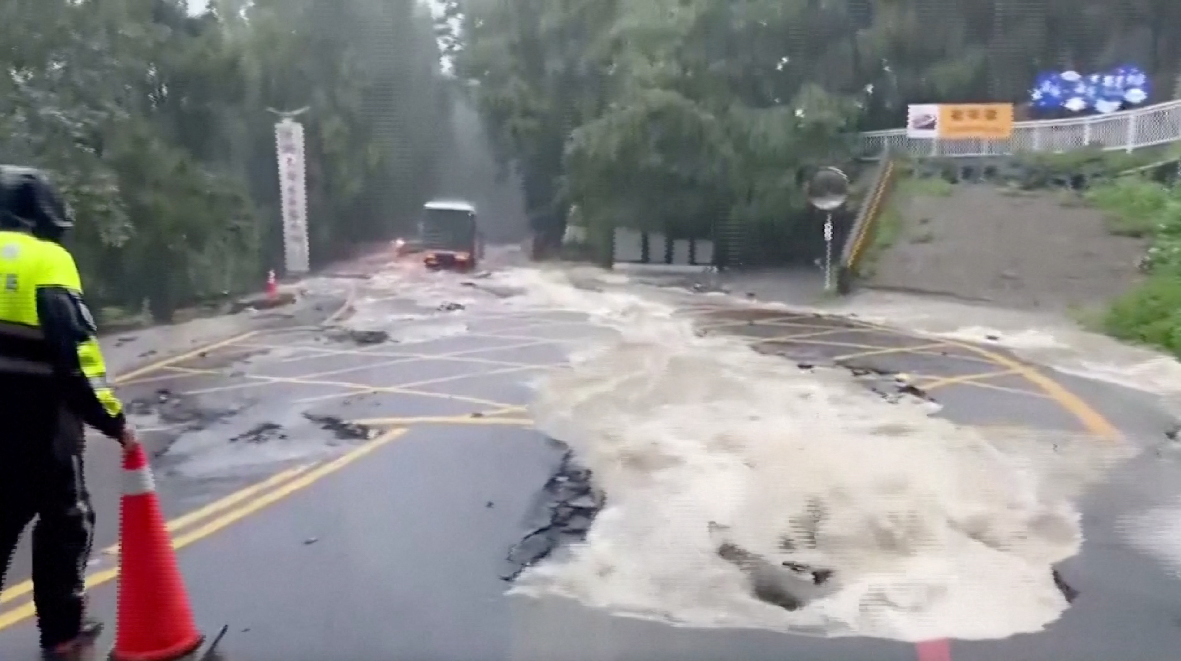A person stands on a flooded street following heavy rains due to Typhoon Khanun, in Nantou county, Taiwan August 5, 2023. 