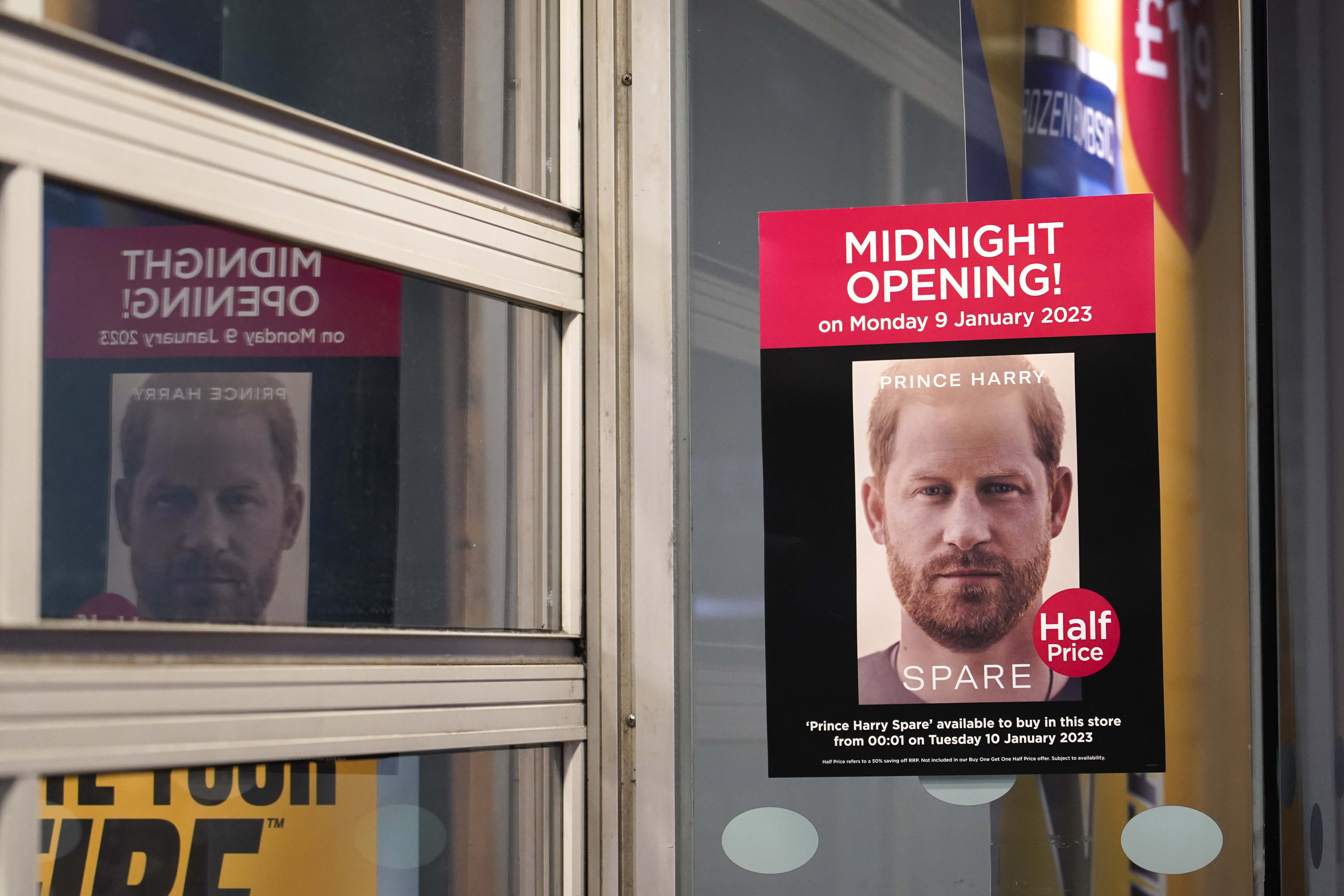 A poster advertises the midnight opening of a store to sell the new book by Prince Harry called "Spare" in London, Tuesday, Jan. 10, 2023. 