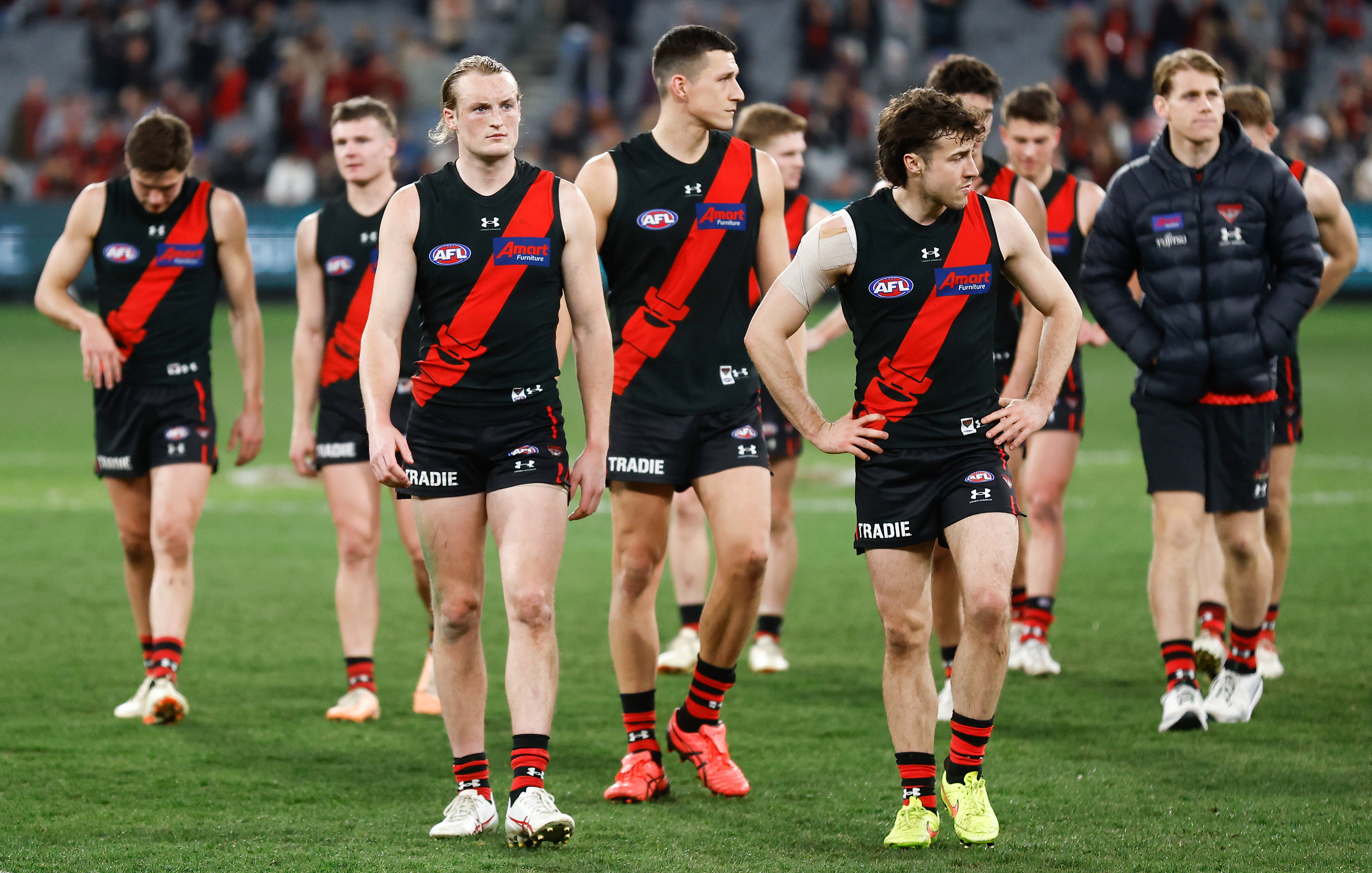 MELBOURNE, AUSTRALIA - AUGUST 25: The Bombers look dejected after a loss during the 2023 AFL Round 24 match between the Essendon Bombers and the Collingwood Magpies at Melbourne Cricket Ground on August 25, 2023 in Melbourne, Australia. (Photo by Michael Willson/AFL Photos via Getty Images)