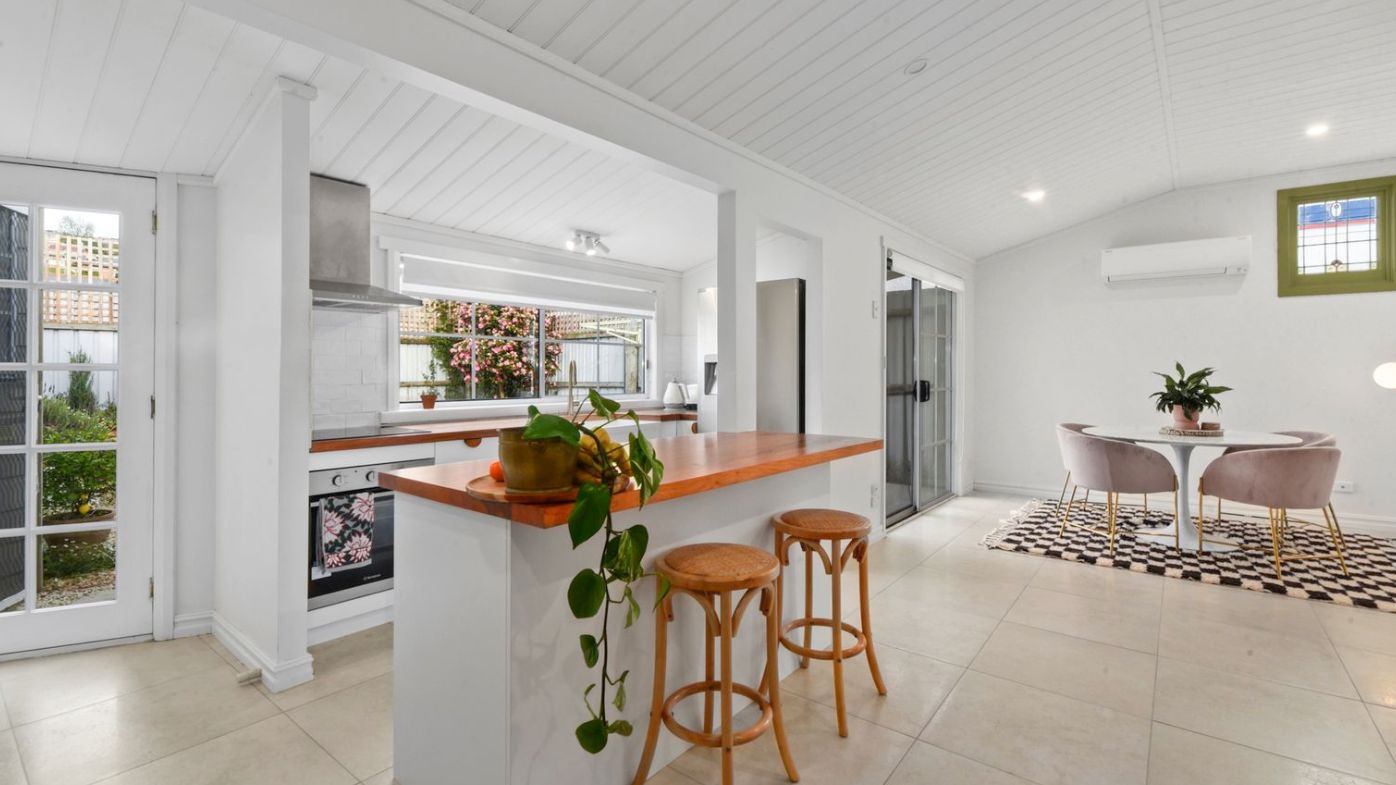 The bright kitchen and dining zone opens to the courtyard.