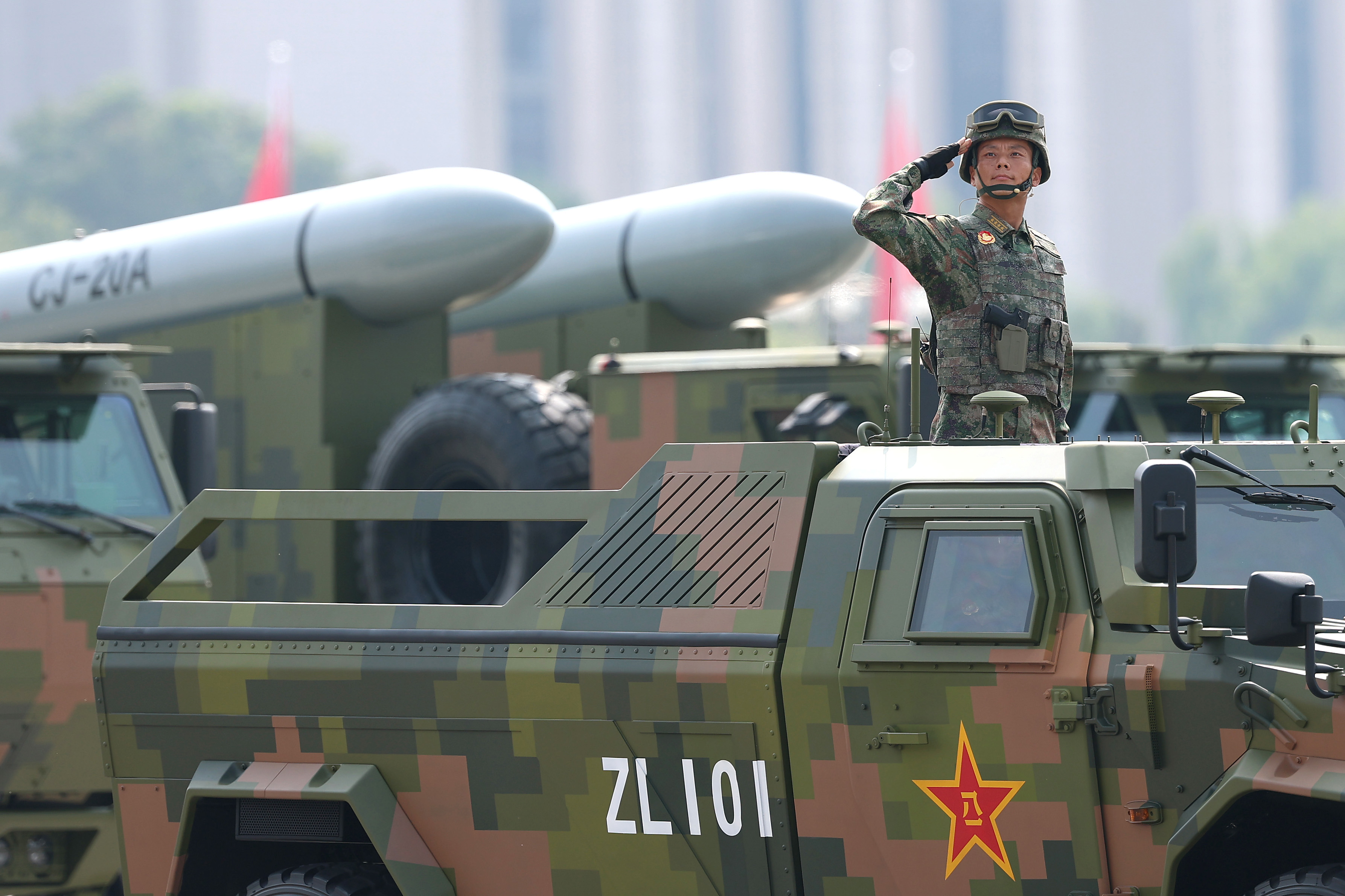 Armoured vehicles and soldiers are seen during the military parade.