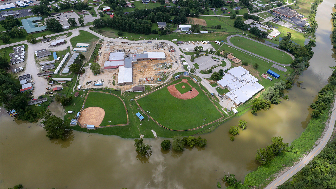 In this aerial image, the river is still high around the homes in Breathitt County, Kentucky, on Saturday, July 30, 2022. Recovery has begun in many of the narrow hollers after historic rains flooded many areas of Eastern Kentucky.