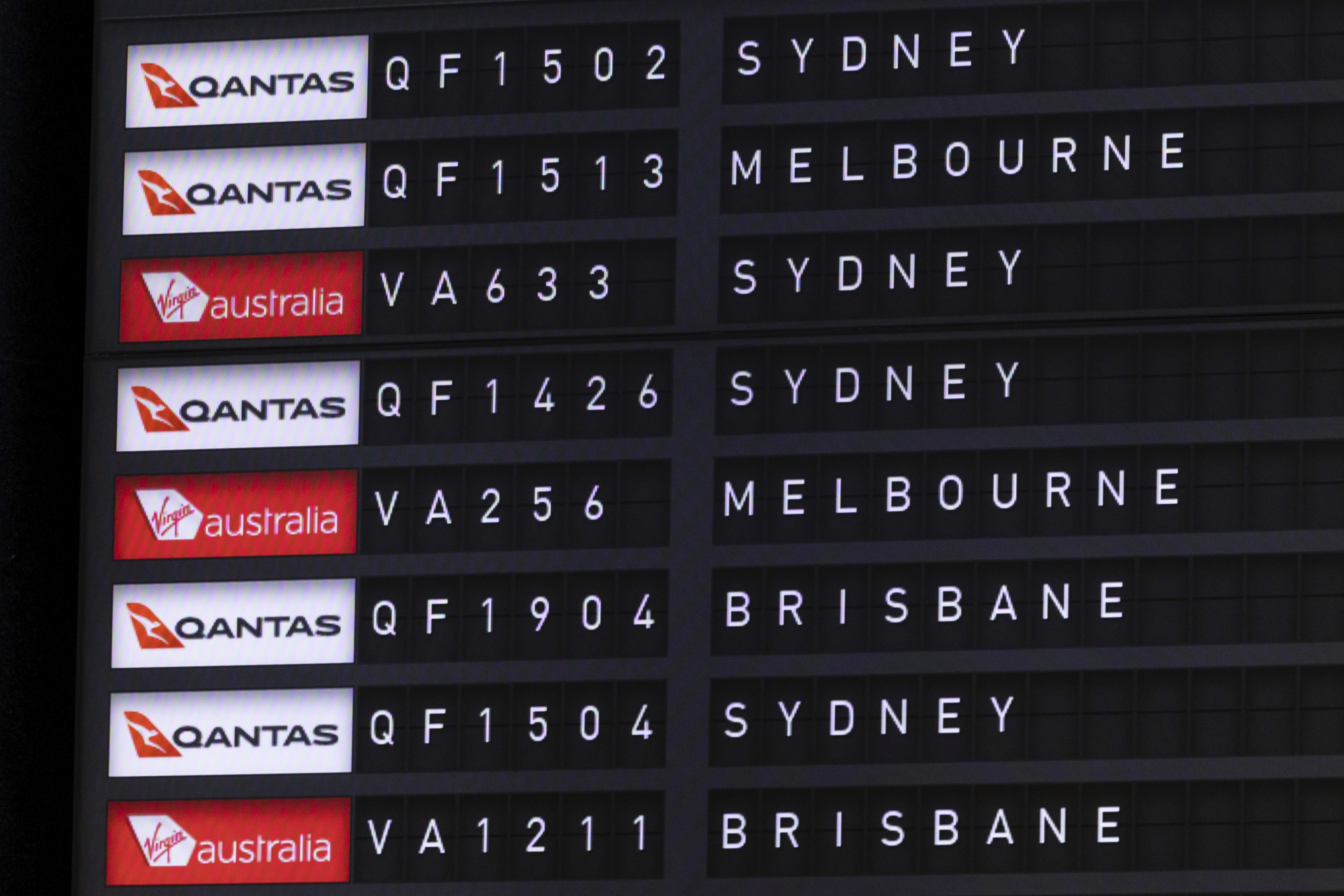 Qantas and Virgin flight details seen on a departure board at Canberra Airport on Thursday 7 September 2023. fedpol Photo: Alex Ellinghausen