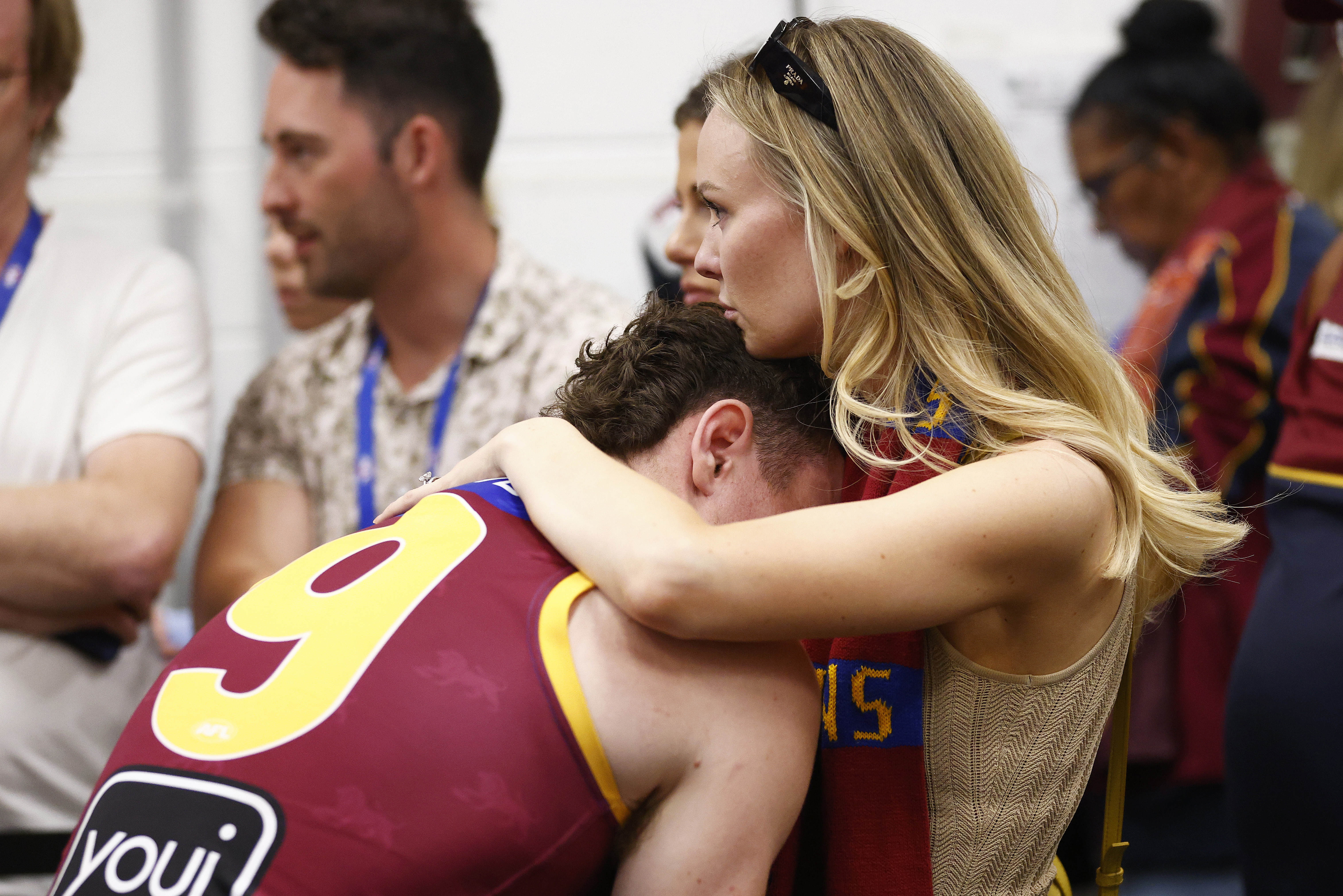 Lachie Neale of the Lions is comforted by wife Jules after their 2023 grand final loss.