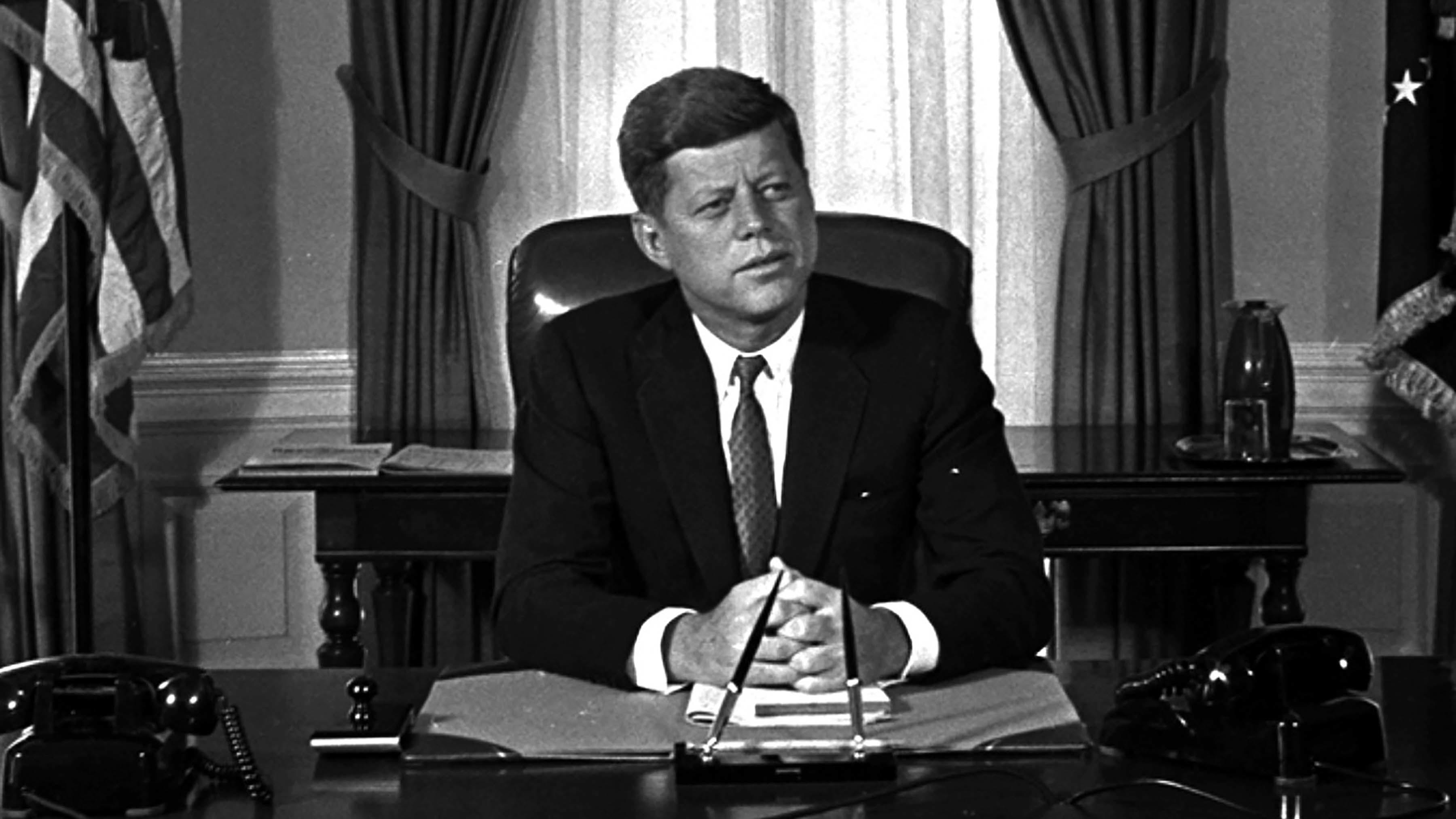 Newly-elected President Kennedy posed for first pictures at his White House desk, Jan. 21, 1961.