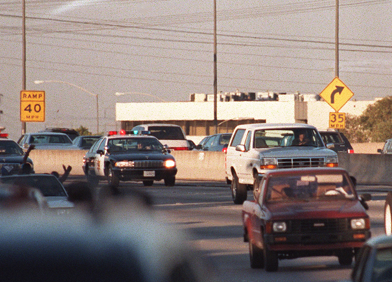 Police cars pursue the white Ford Bronco driven by Al Cowlings, carrying O.J. Simpson on June 17, 1994 on the 405 freeway in Los Angeles.