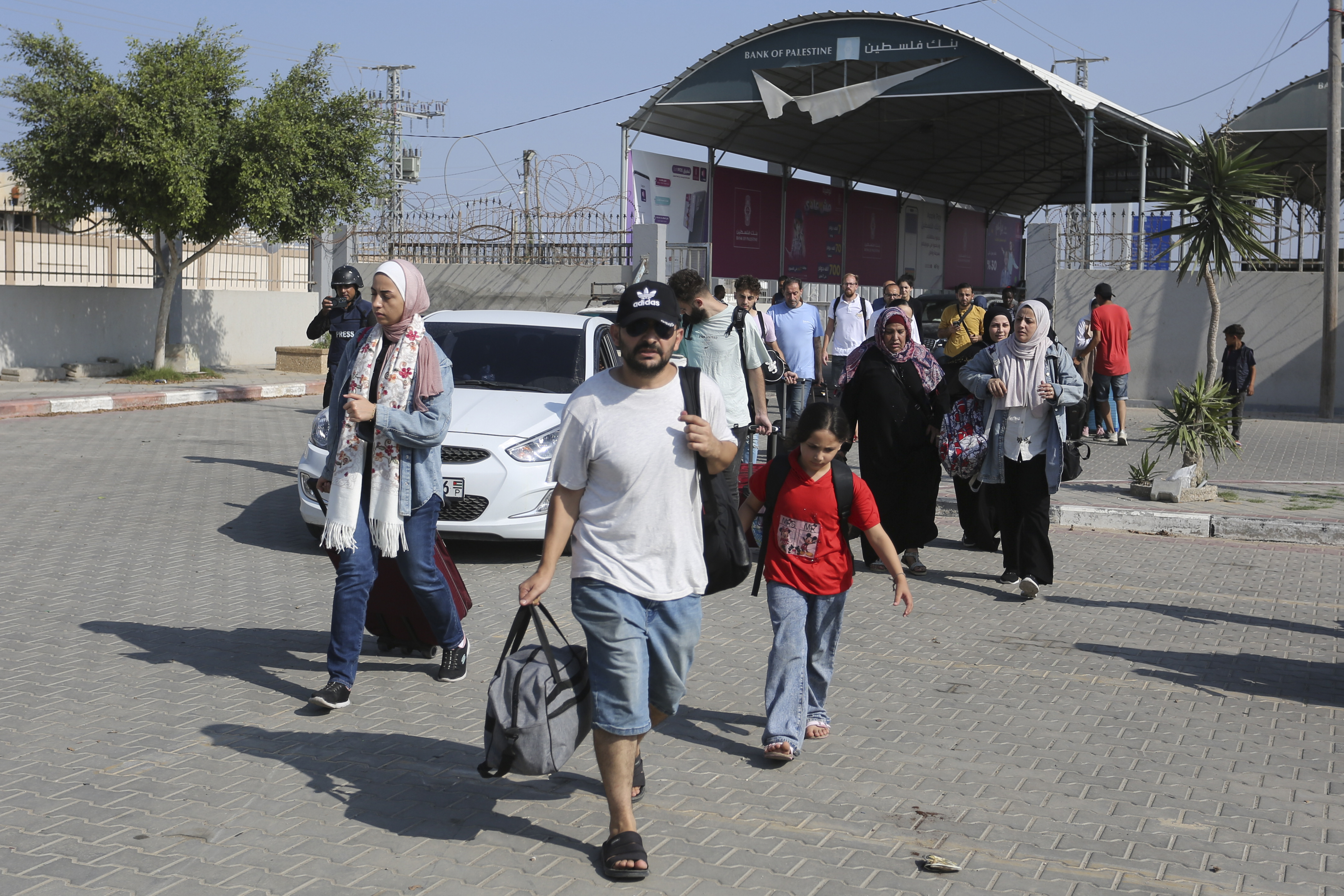 Palestinians cross to the Egyptian side of the Rafah border