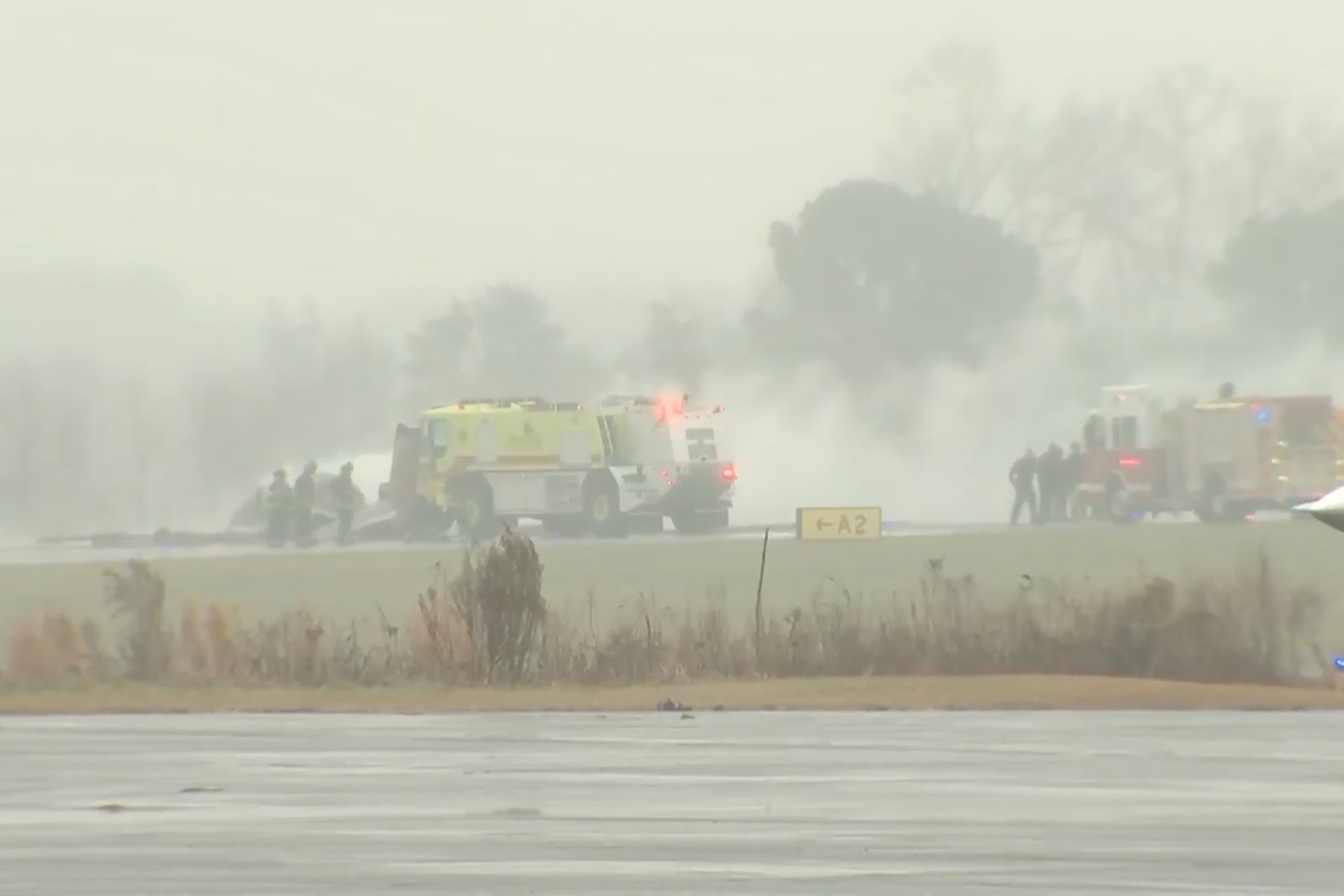 This screengrab made from video provided by WSOC shows firefighting crews responding to a reported plane crash at a regional airport in Statesville, N.C., erupting in a large fire, Thursday, Dec. 18, 2025. (WSOC via AP)
