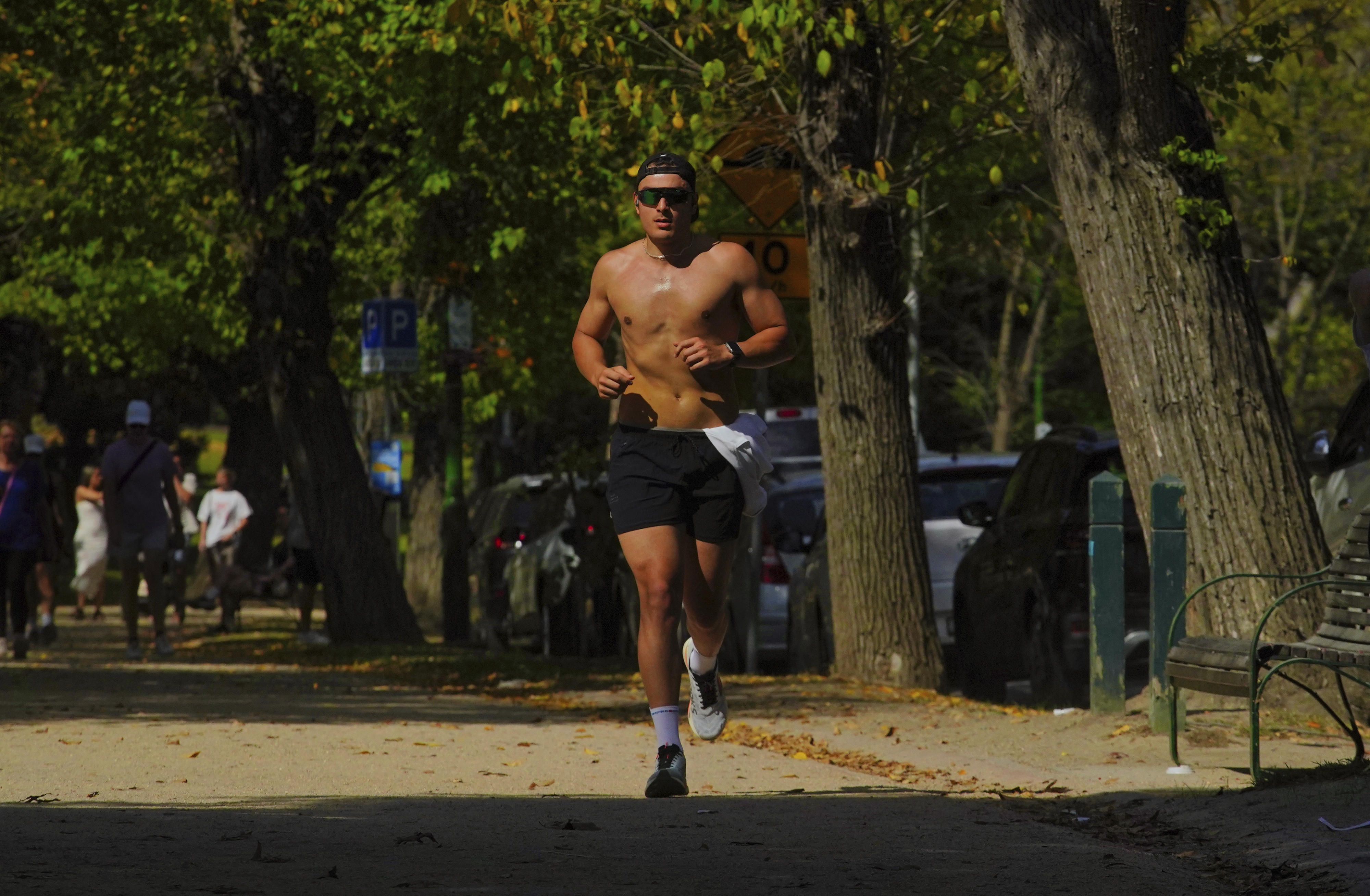 People are seen enjoying the warm weather around the TAMs in Melbourne  on Sunday  13 April 2025. 