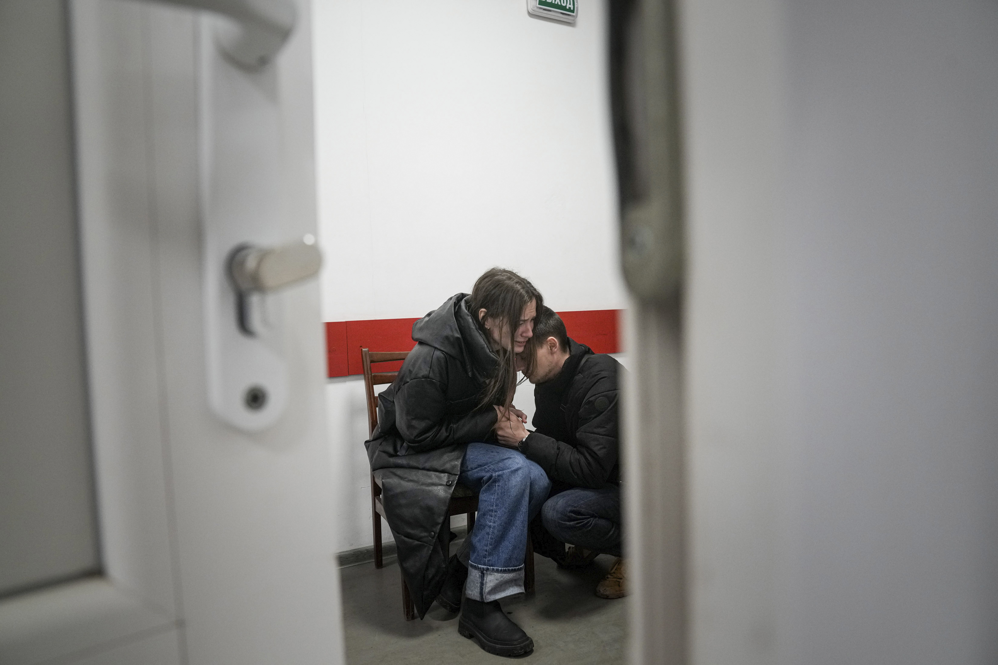 Marina Yatsko and her boyfriend Fedor comfort each other after her 18-month-old son Kirill was killed by shelling in a hospital in Mariupol, Ukraine, Friday, March 4, 2022.