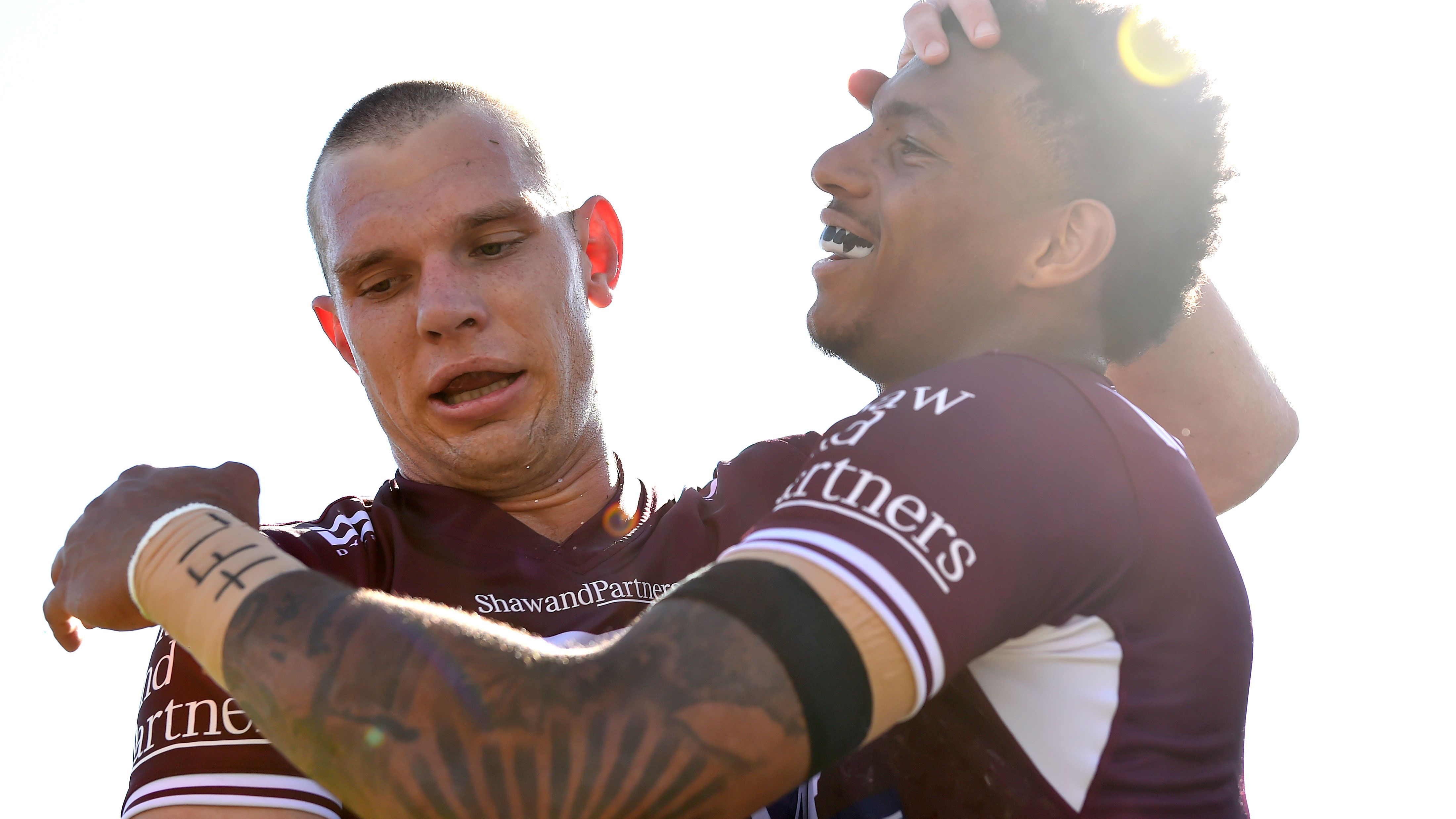 Manly gun Tom Trbojevic celebrates a try with winger Jason Saab.