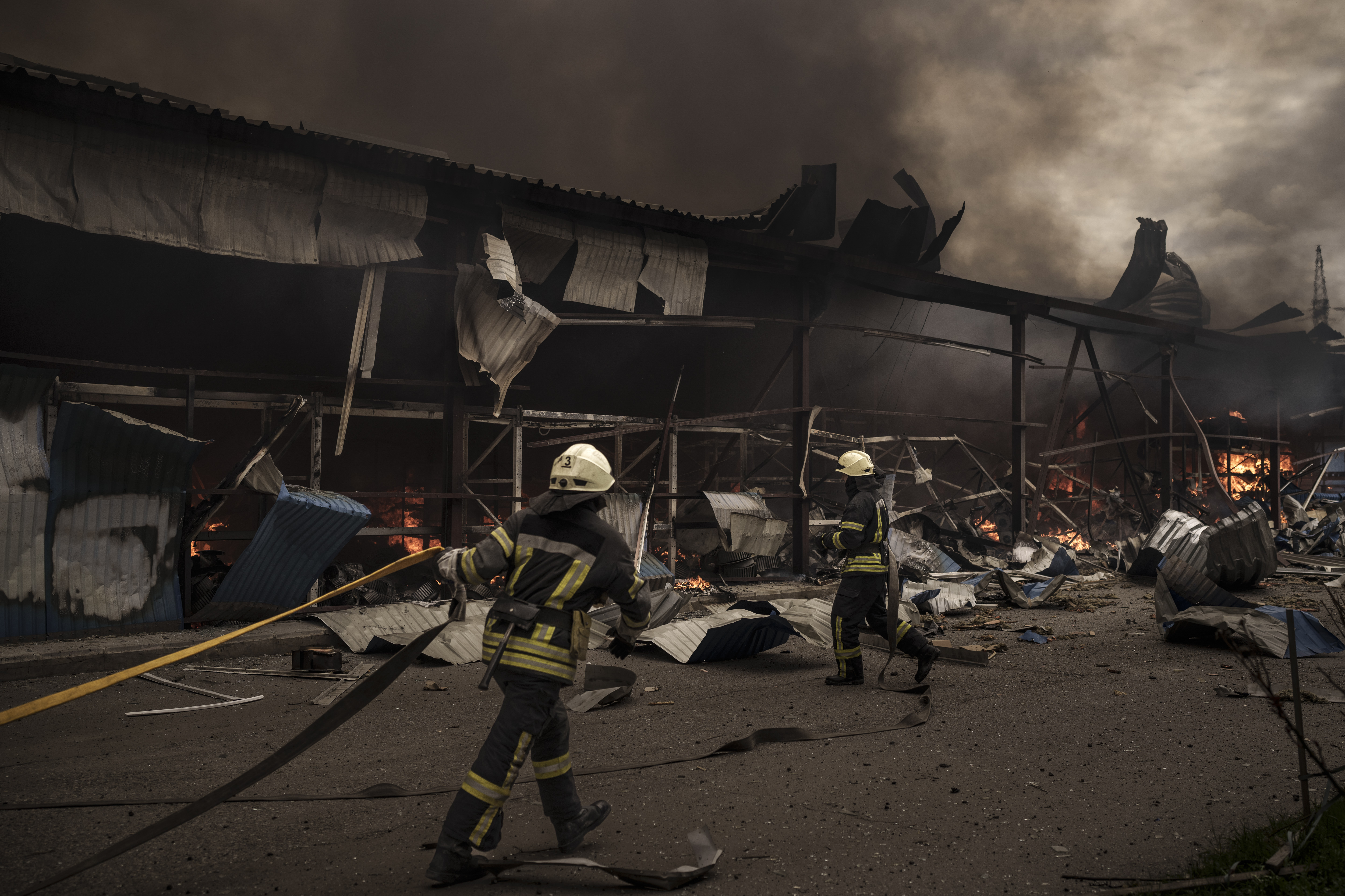 Firefighters work to extinguish a fire on a warehouse amid Russian bombardments in Kharkiv, Ukraine on Saturday, April 23.