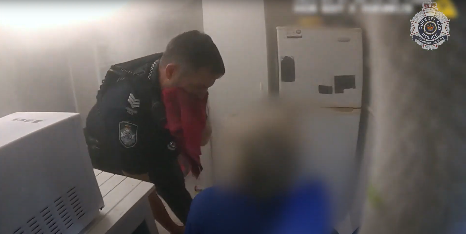 Dramatic vision has captured the moment police officers rescued an elderly couple, one of whom was in a wheelchair, and their grandson from flames that engulfed their home on the Gold Coast.