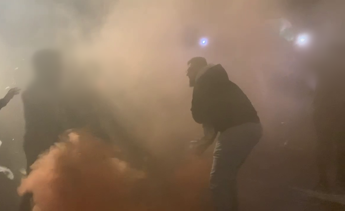 A man appears to throw a flare during a protest