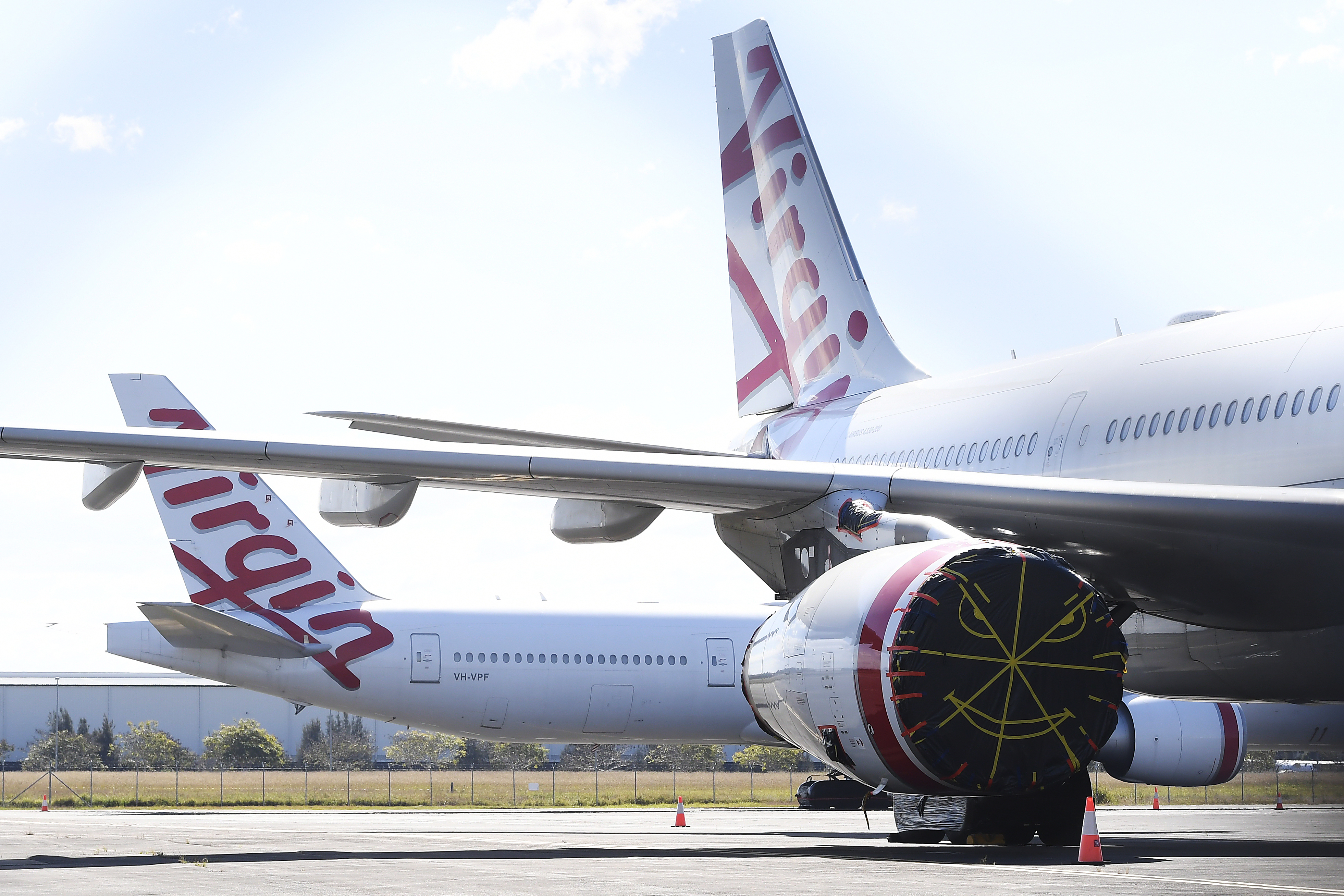 BRISBANE, AUSTRALIA - AUGUST 05: Virgin Australia wide-body aircrafts are seen parked in the Brisbane Airport on August 05, 2020 in Brisbane, Australia. Virgin Australia has announced 3000 job cuts as part of a radical cost reduction strategy for the airline, while its discount provider Tiger Air will close. (Photo by Albert Perez/Getty Images)