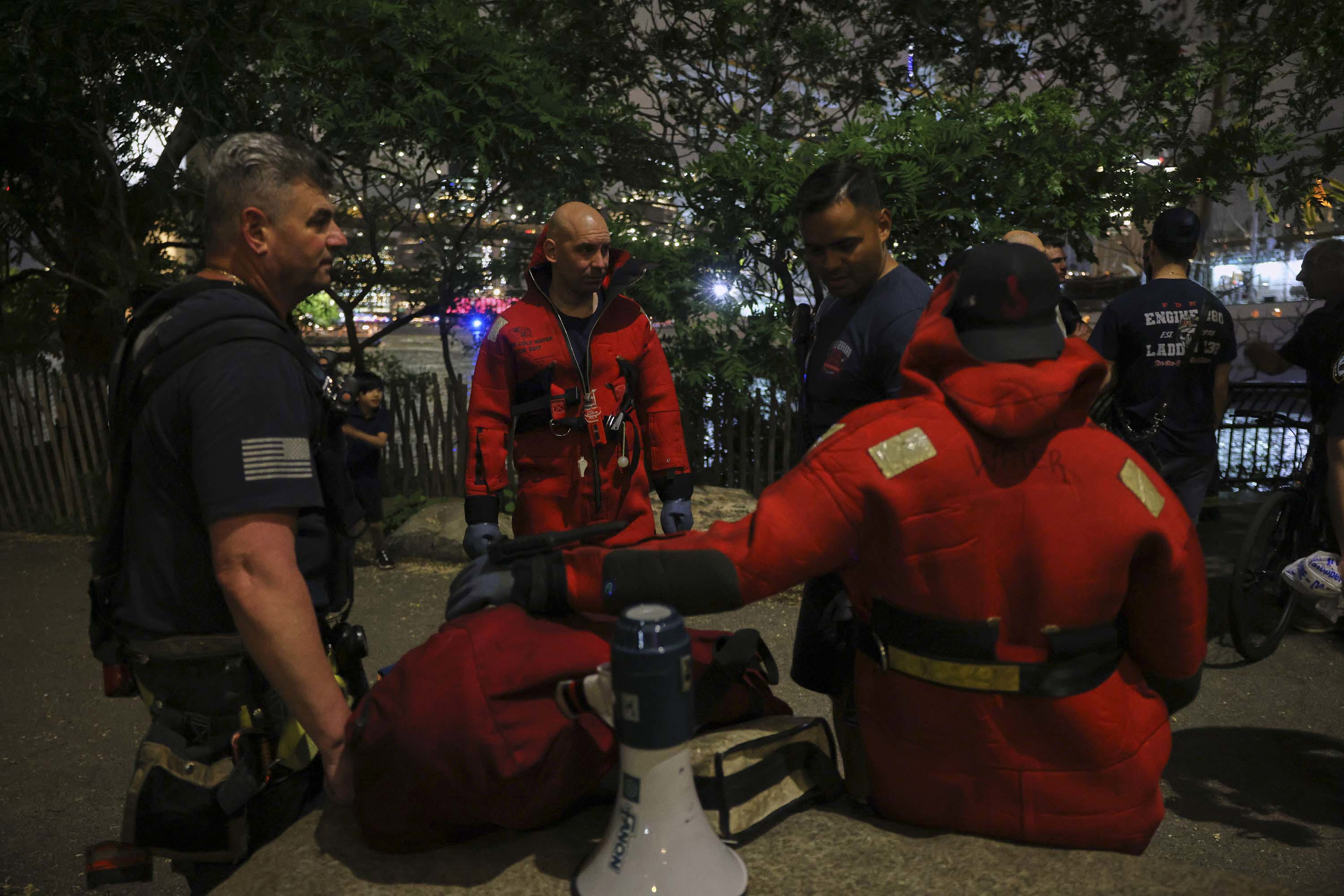 New York Fire Department divers prepare to dive the East River after a masted Mexican Navy training ship collided with the Brooklyn Bridge.