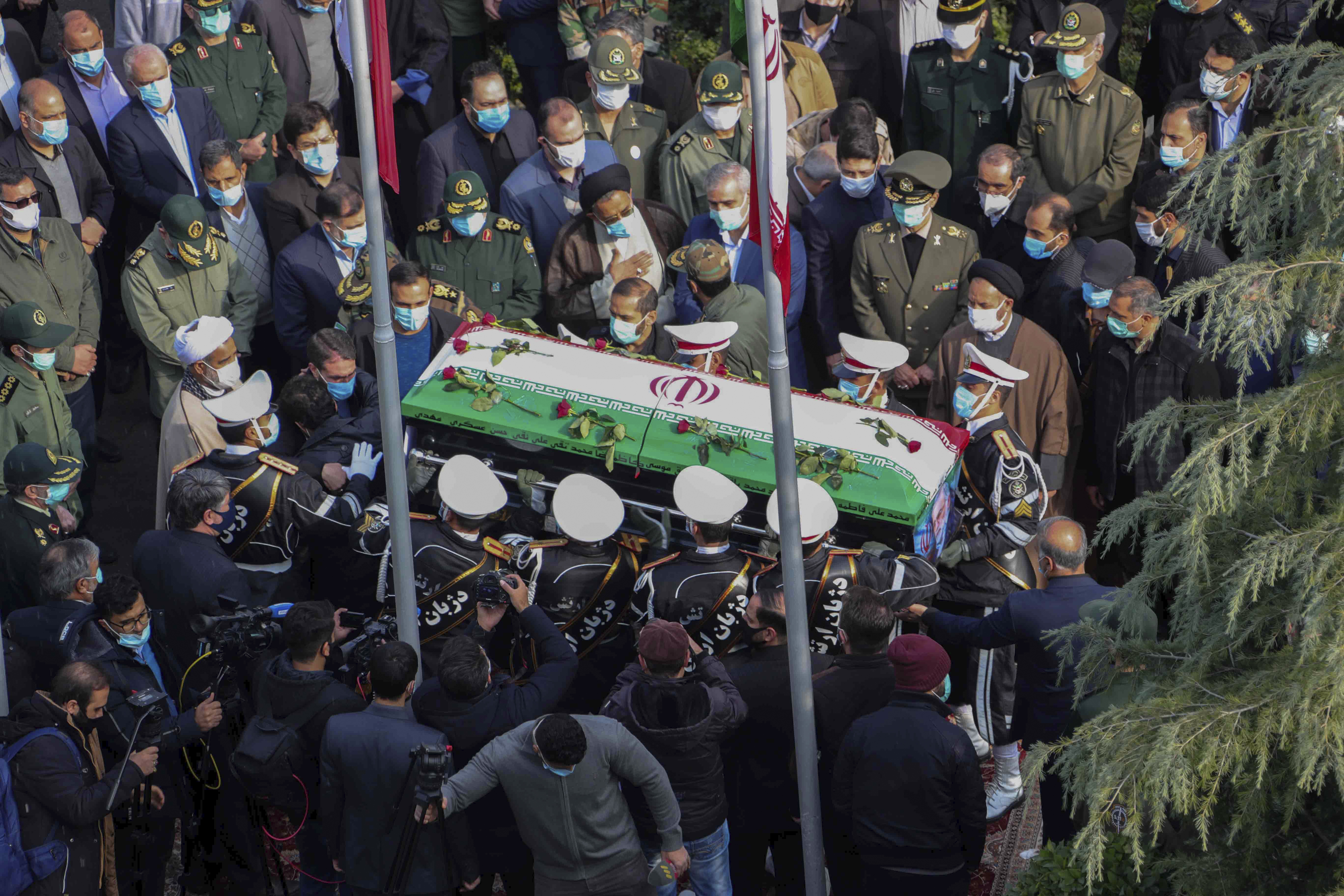 In this photo released by the official website of the Iranian Defense Ministry, military personnel carry the flag draped coffin of Mohsen Fakhrizadeh, a scientist who was killed on Friday, in a funeral ceremony in Tehran, Iran, Monday, Nov. 30, 2020. Iran held the funeral service for Fakhrizadeh, who founded its military nuclear program two decades ago, with the Islamic Republic's defense minister vowing to continue the man's work 