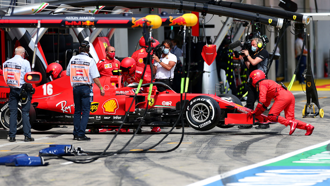 Charles Leclerc's Ferrari is pushed into the garage as he retires from the Styrian Grand Prix after colliding with Sebastian Vettel.