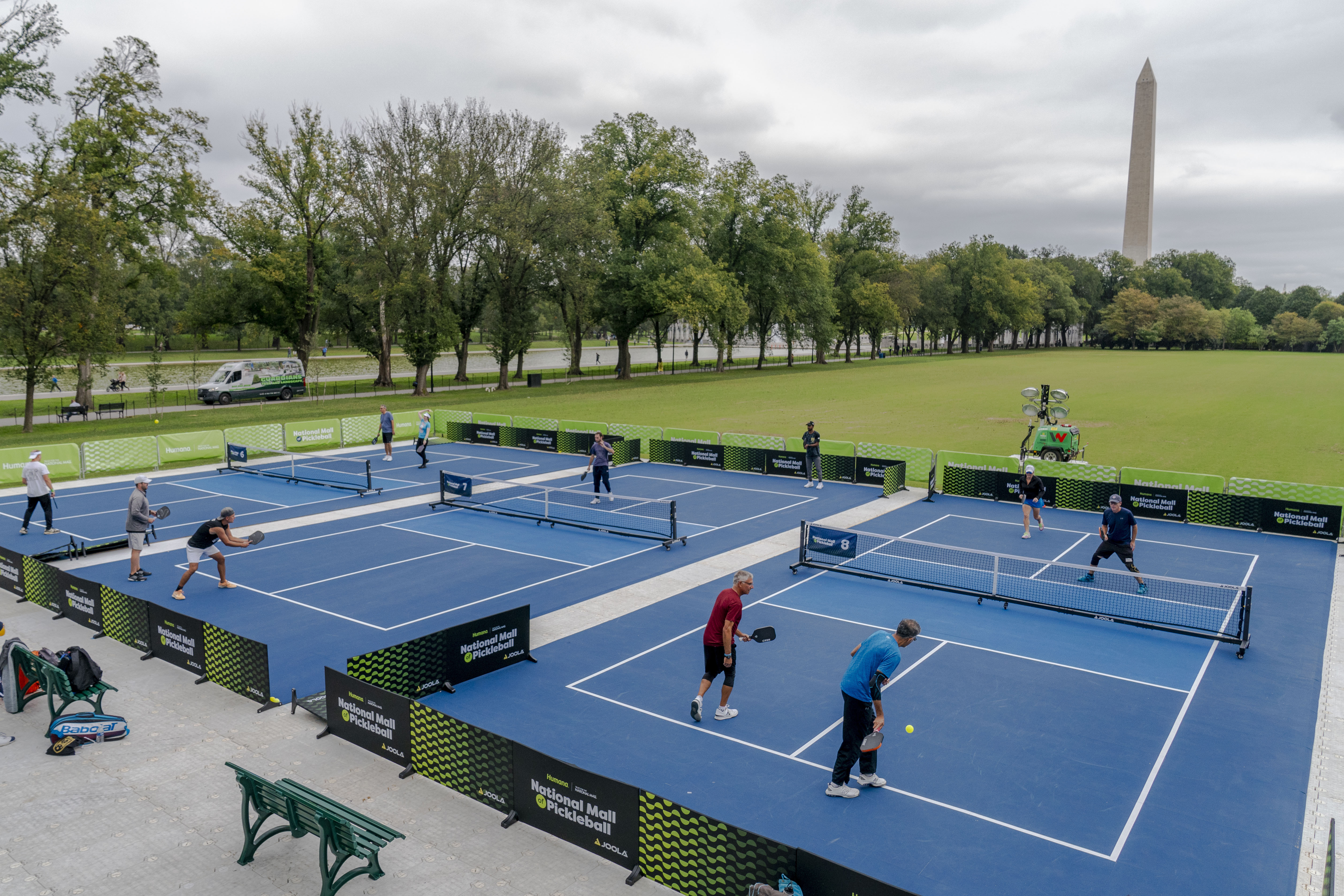 The Washington Monument is visible as the National Mall hosts a pickleball event on the JFK Hockey Fields along the Reflecting Pool in Washington, Thursday, Sept. 28, 2023. For three days ending Saturday, the National Mall will host a free event open to the public to celebrate pickle ball. (AP Photo/Andrew Harnik)