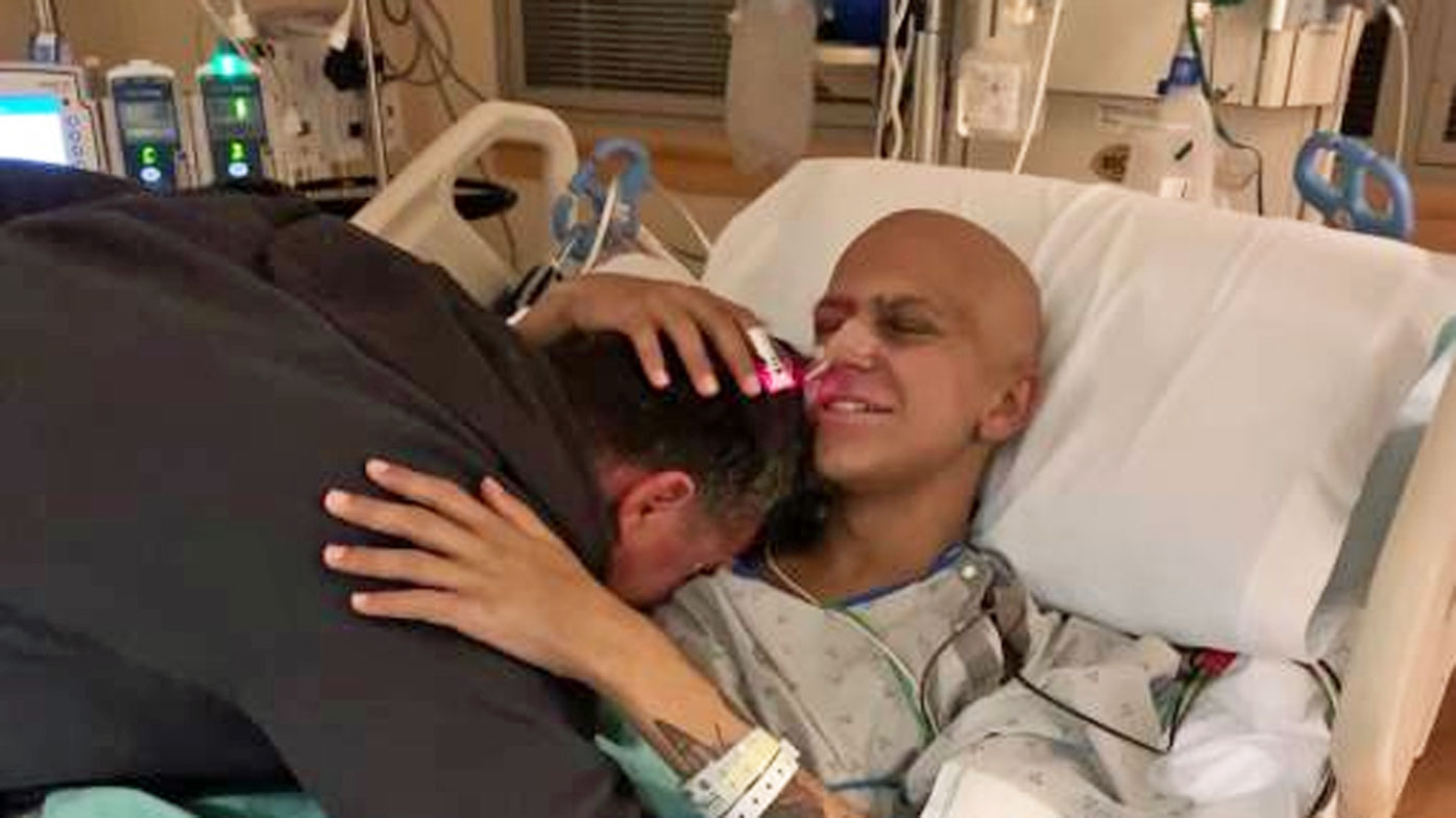 Ben Sylo travelled to the US last year to get a bone marrow transplant. Complications saw him placed on life support. Mr Sylo's stepfather Russell in pictured giving him a hug at his US hospital after he came off life support.