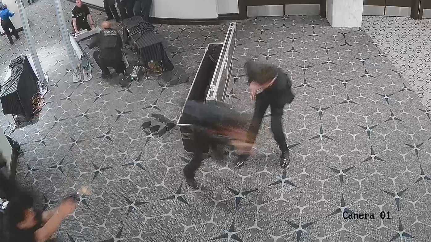 An officer (bottom left) fires at Allen as a Secret Service agent stands behind him.