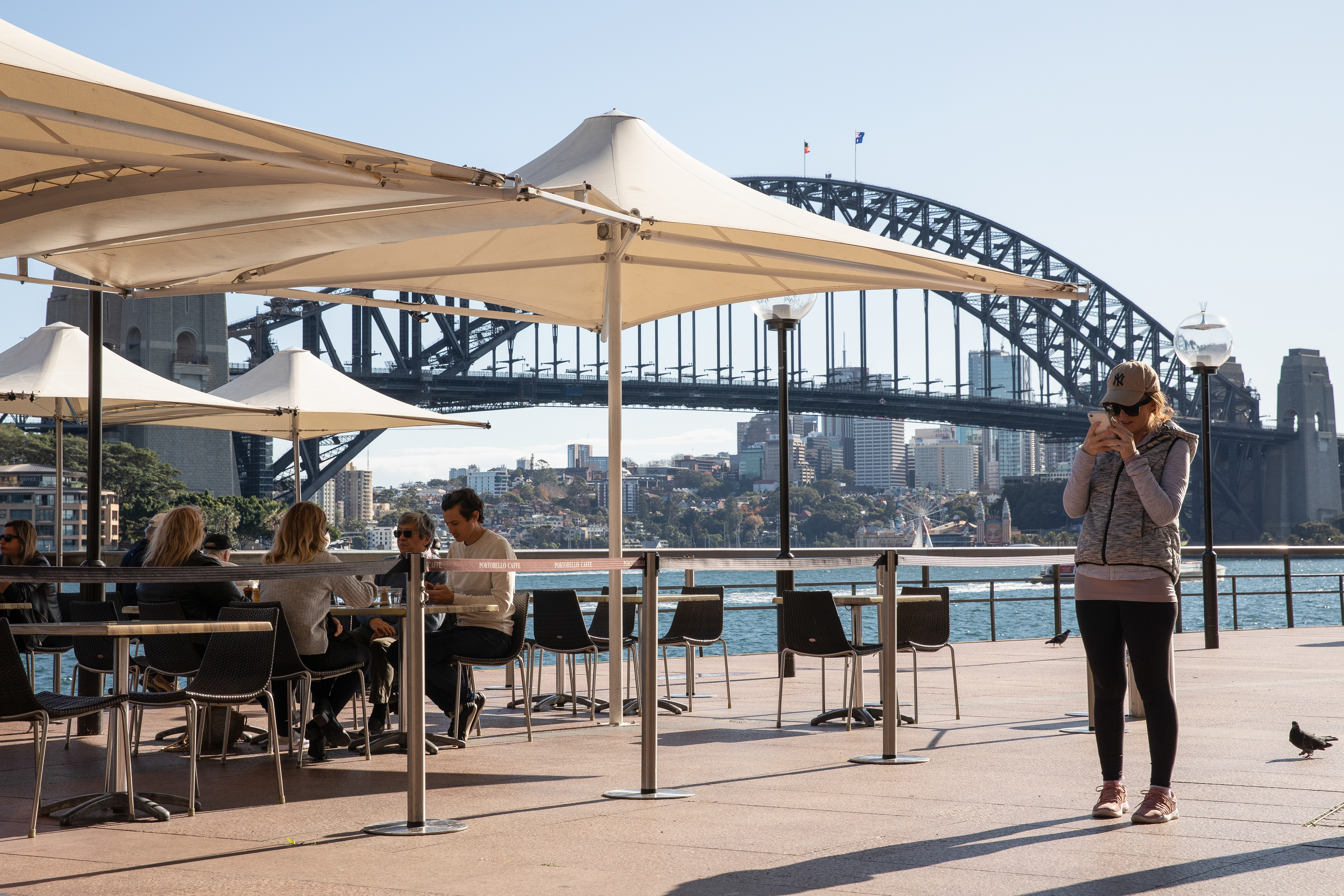 Many owners say it won't be sustainable for them to reopen if they are forced to close for a fortnight whenever a case is linked to the venue. Diners eat at the Portobello Caffe at Circular Quay on June 01, 2020 in Sydney, Australia. 