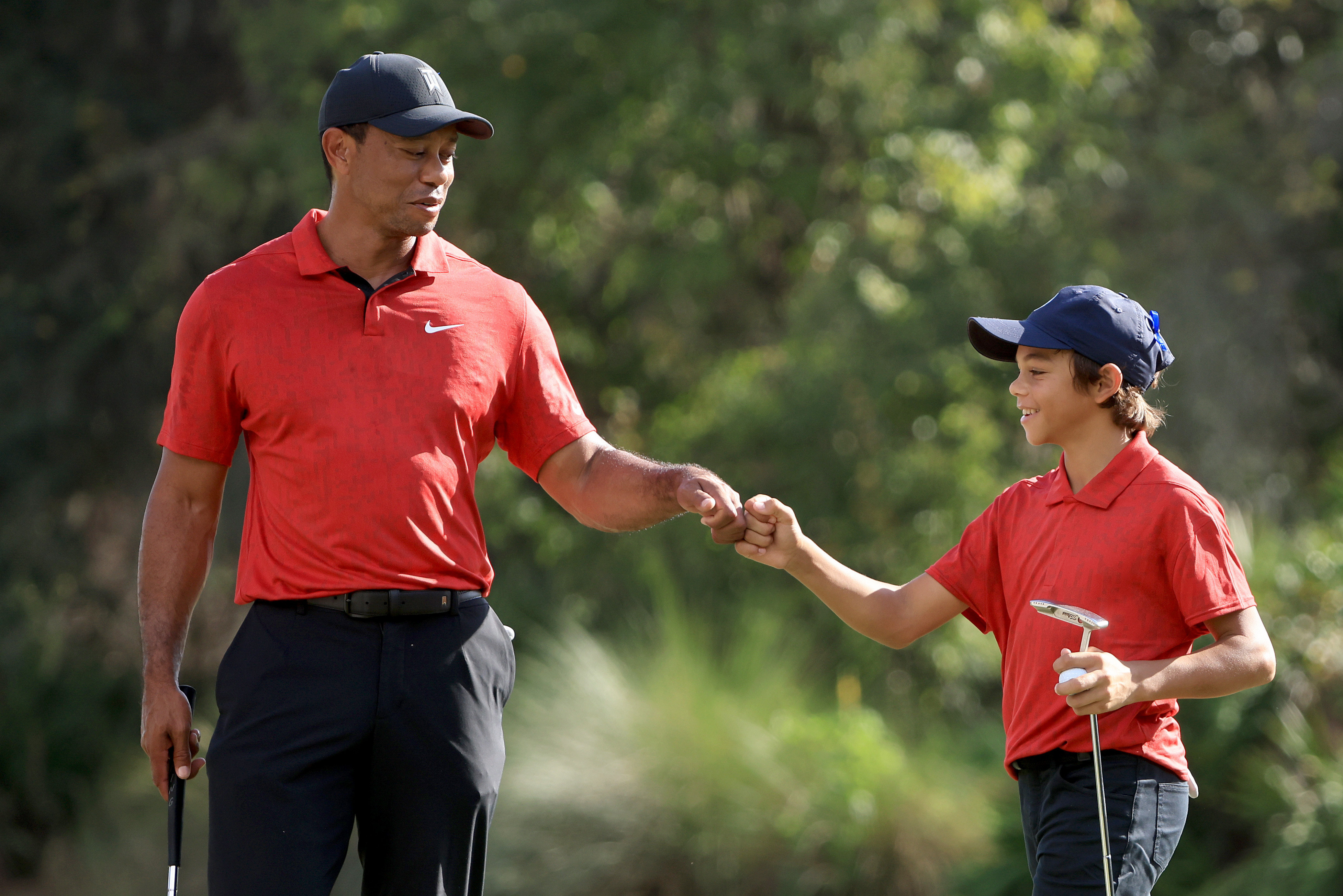 Tiger Woods and Charlie Woods celebrate a birdie on the 12th hole during the final round of the PNC Championship.
