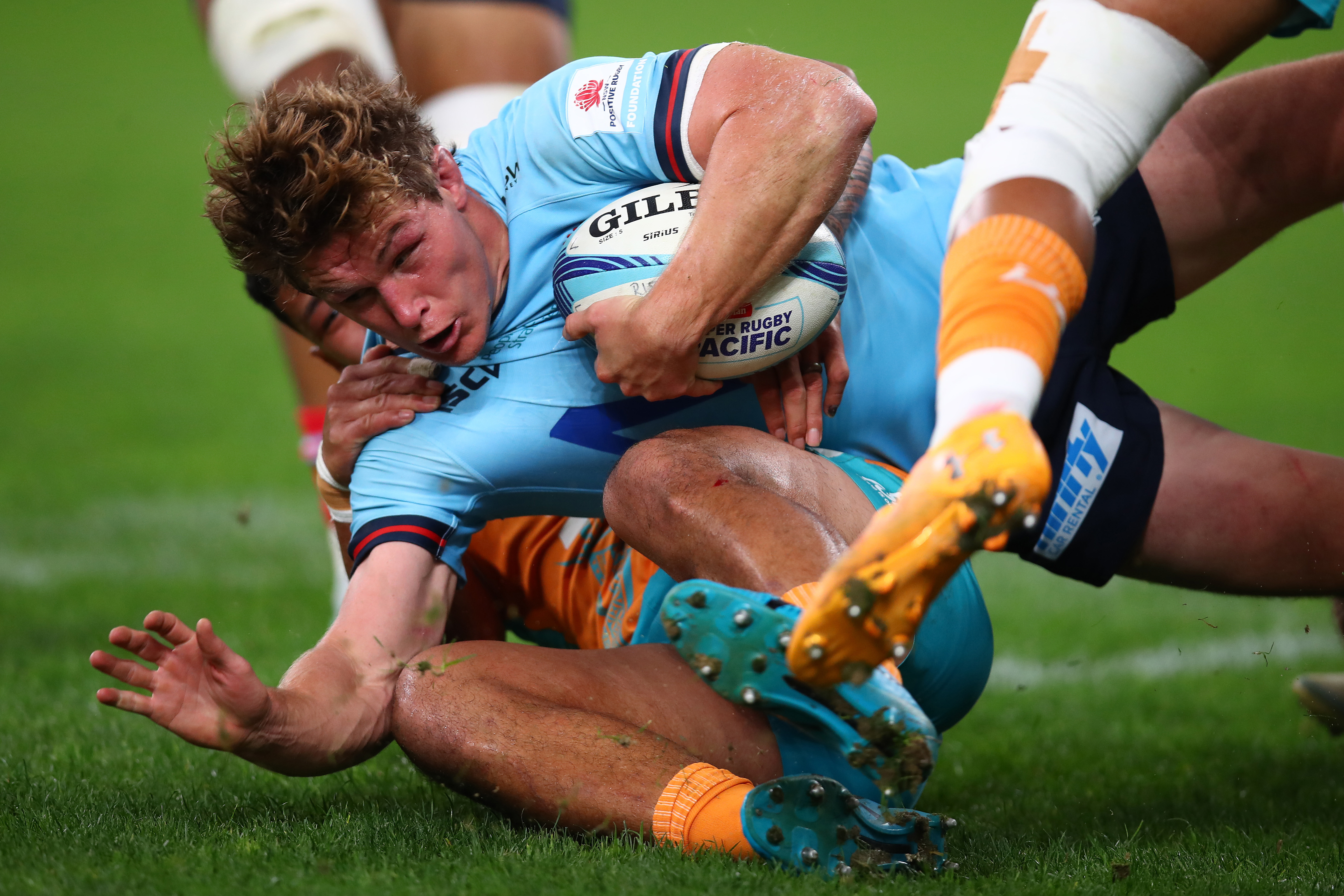 Michael Hooper of the Waratahs is tackled at Allianz Stadium.