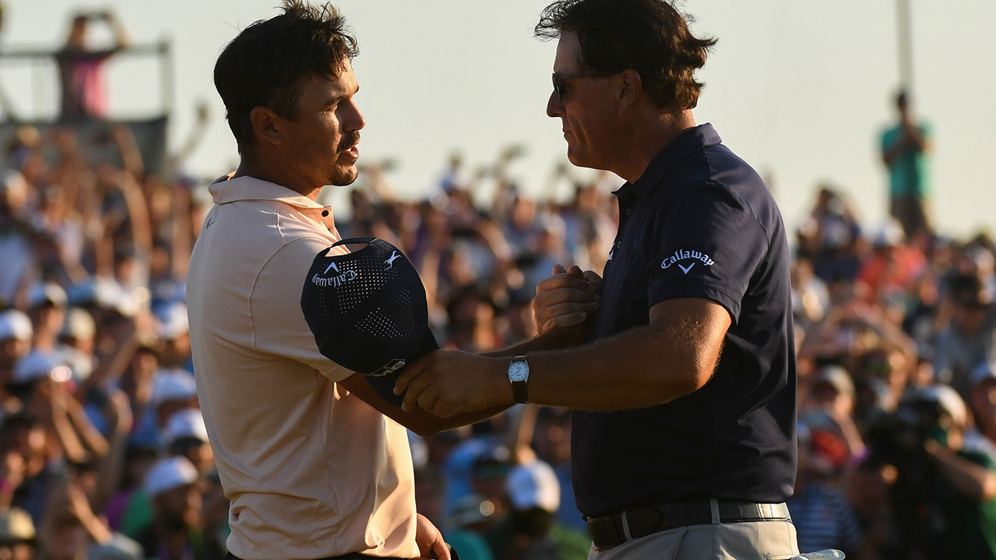 Brooks Koepka congratulates Phil Mickelson after he became the oldest winner of a golf major in history.