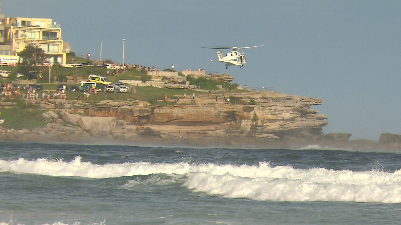 A rescue helicopter was called in to help locate the man in rough surf. 