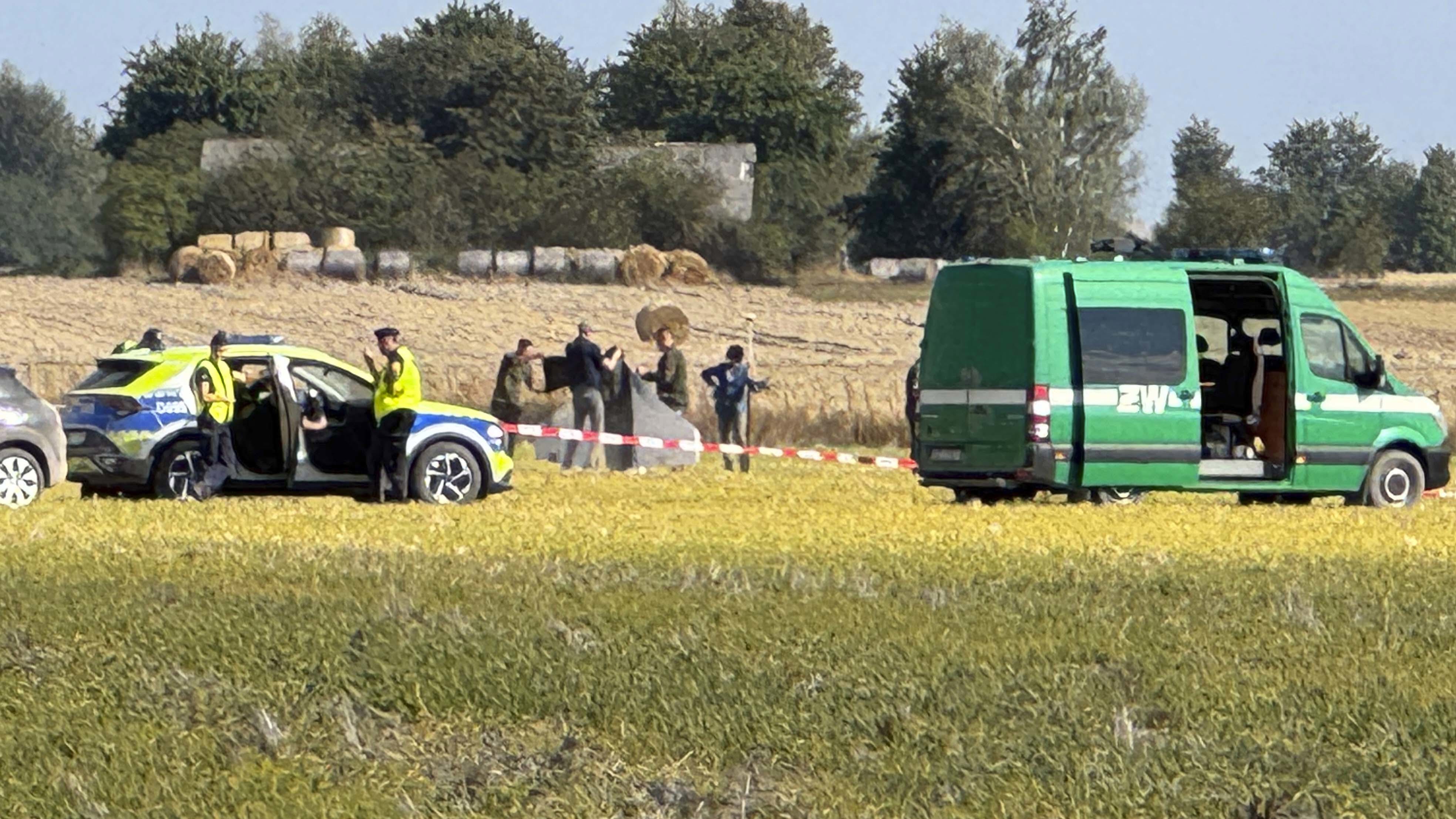 Police and Military Police secure parts of a damaged UAV shot down by Polish authorities at a site in Wohyn, Poland.