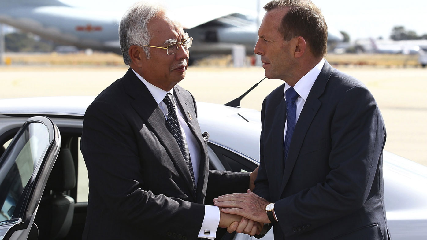  In this April 3, 2014, file photo, Australian then Prime Minister Tony Abbott, right, shakes hands with Malaysian then Prime Minister Najib Razak as Razak prepares to depart Australia after his visit during the search of the missing Malaysia Airlines flight MH370 at Perth International Airport, Australia. Abbott has claimed the "top levels" of the Malaysian government long suspected the vanishing of a plane almost six years ago was a mass murder-suicide by the pilot. 