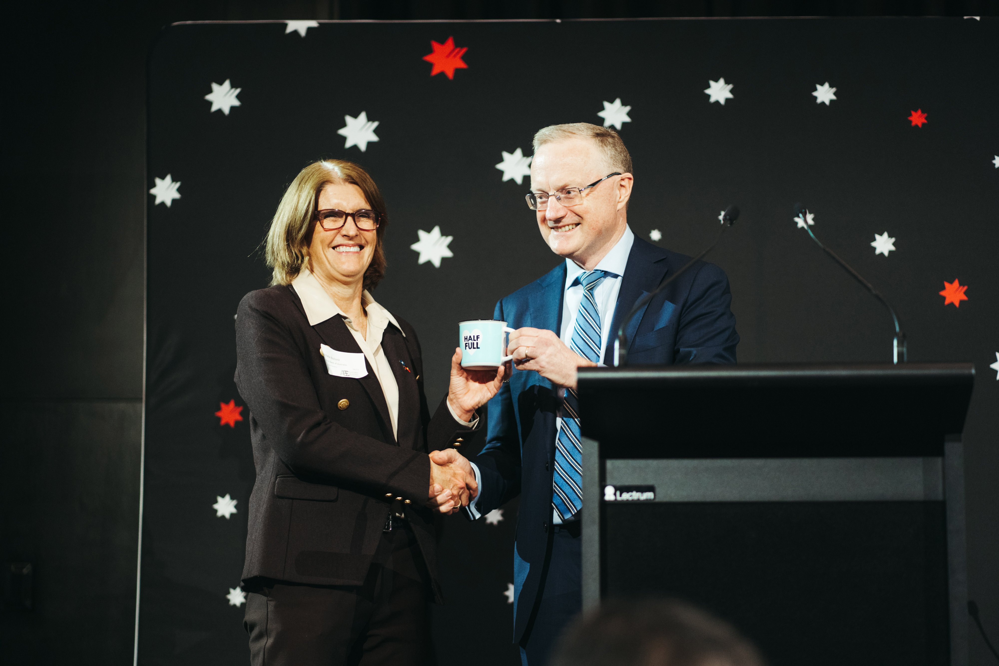 Newly appointed Governor Michele Bullock receiving a mug from Philip Lowe