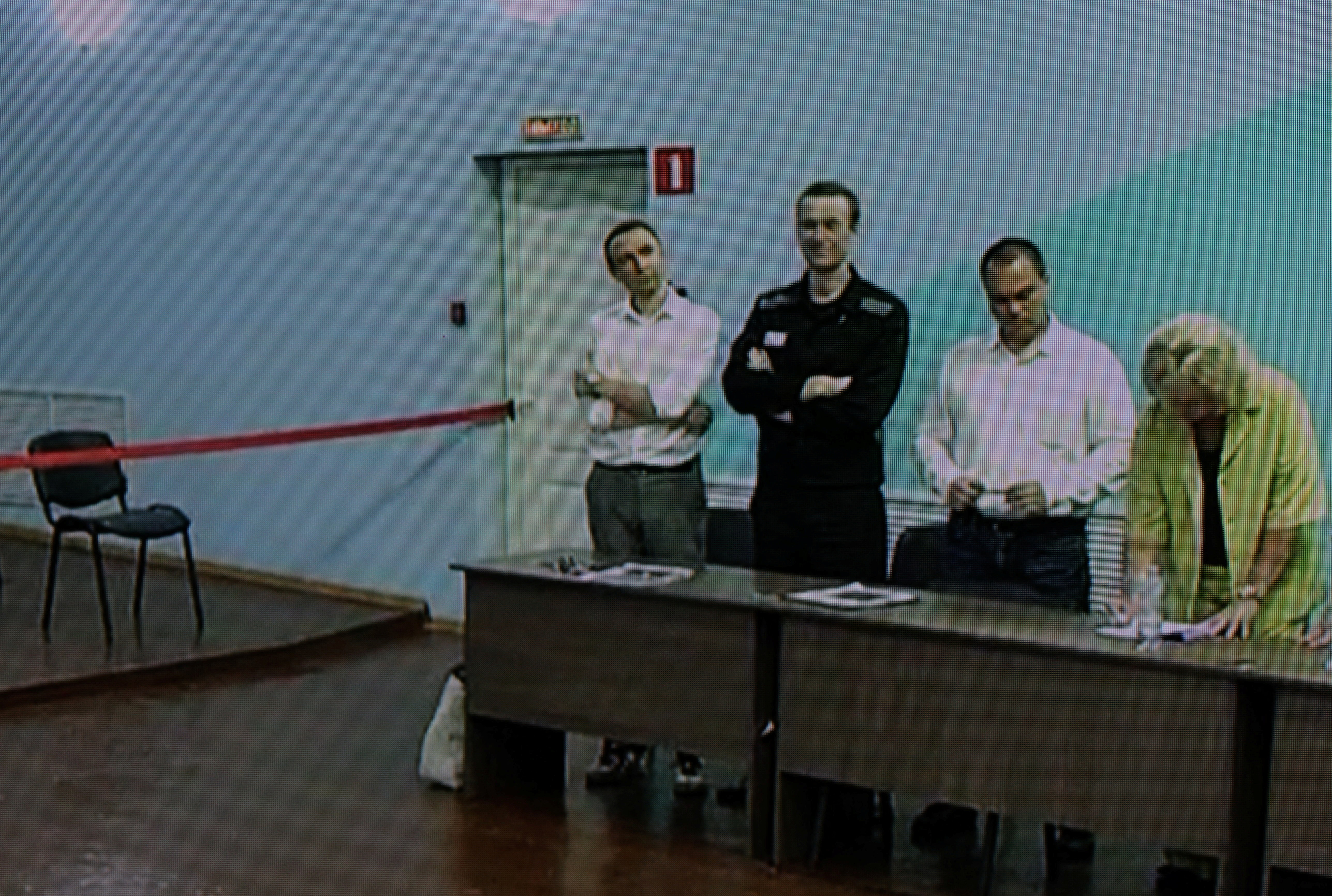 Russian opposition politician Alexei Navalny and his lawyers Olga Mikhailova, Vadim Kobzev and Alexander Fedulov appear on a screen via video link during an external hearing of the Moscow City Court in the criminal case against Navalny on numerous charges, including the creation of an extremist organization, at the IK-6 penal colony in Melekhovo in the Vladimir region, Russia, August 4, 2023. 