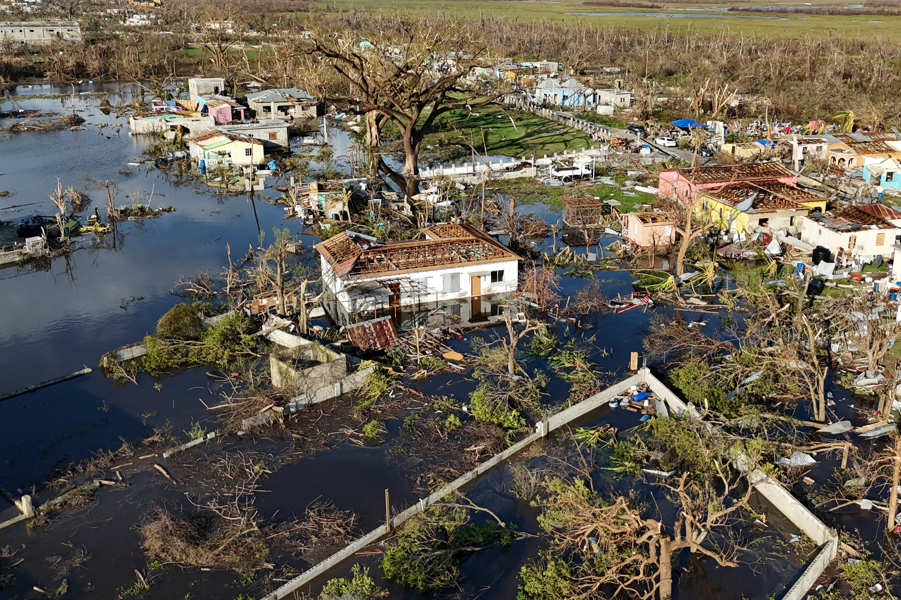 FILE - Debris surrounds damaged homes along the Black River, Jamaica, Thursday, Oct. 30, 2025, in the aftermath of Hurricane Melissa.  (AP Photo/Matias Delacroix, File)