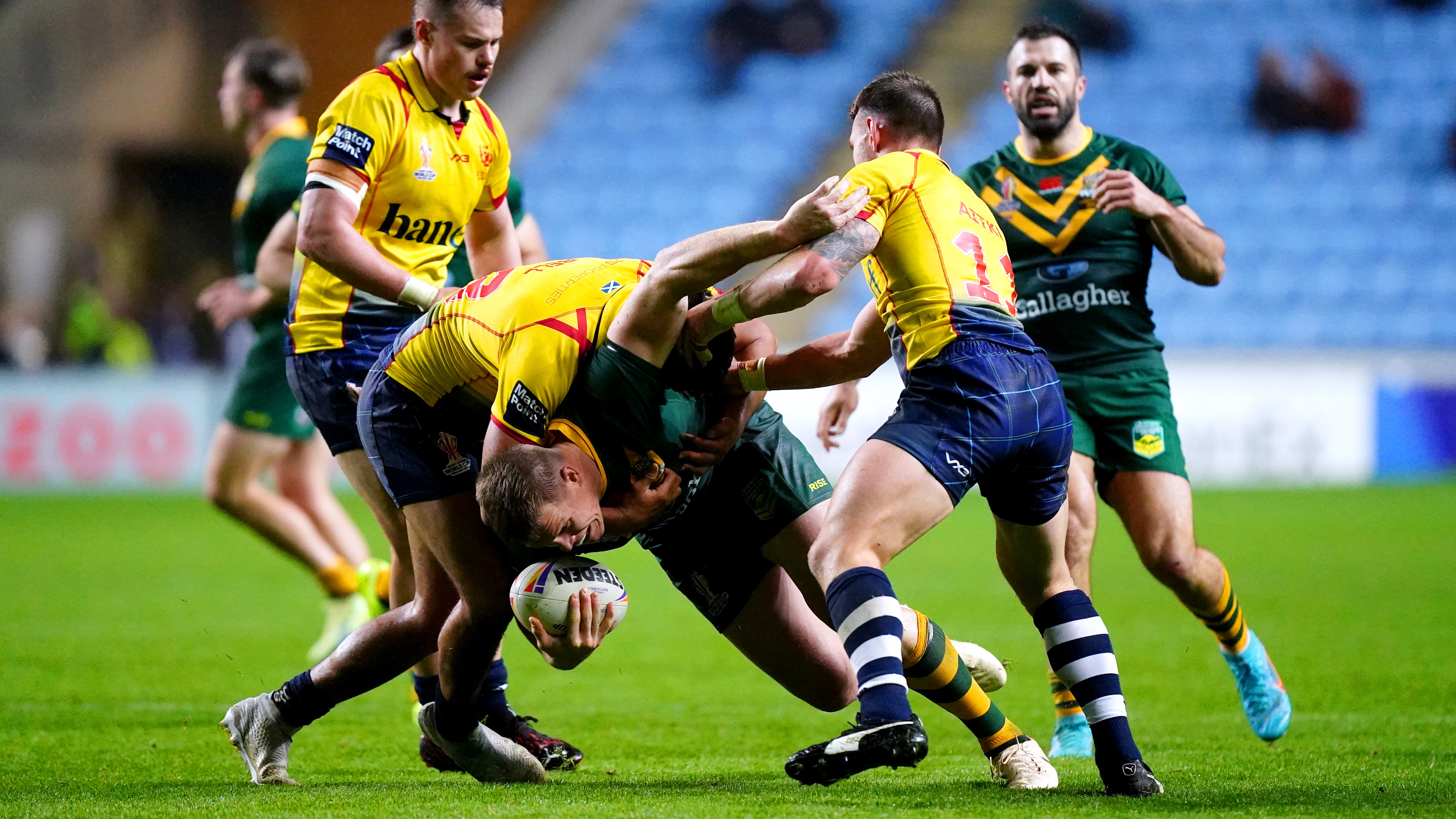 Australia's Lindsay Collins is tackled by Scotland's Euan Aitken (second right) during the Rugby League World Cup group B match at the Coventry Building Society Arena, Coventry. Picture date: Friday October 21, 2022. (Photo by Mike Egerton/PA Images via Getty Images)