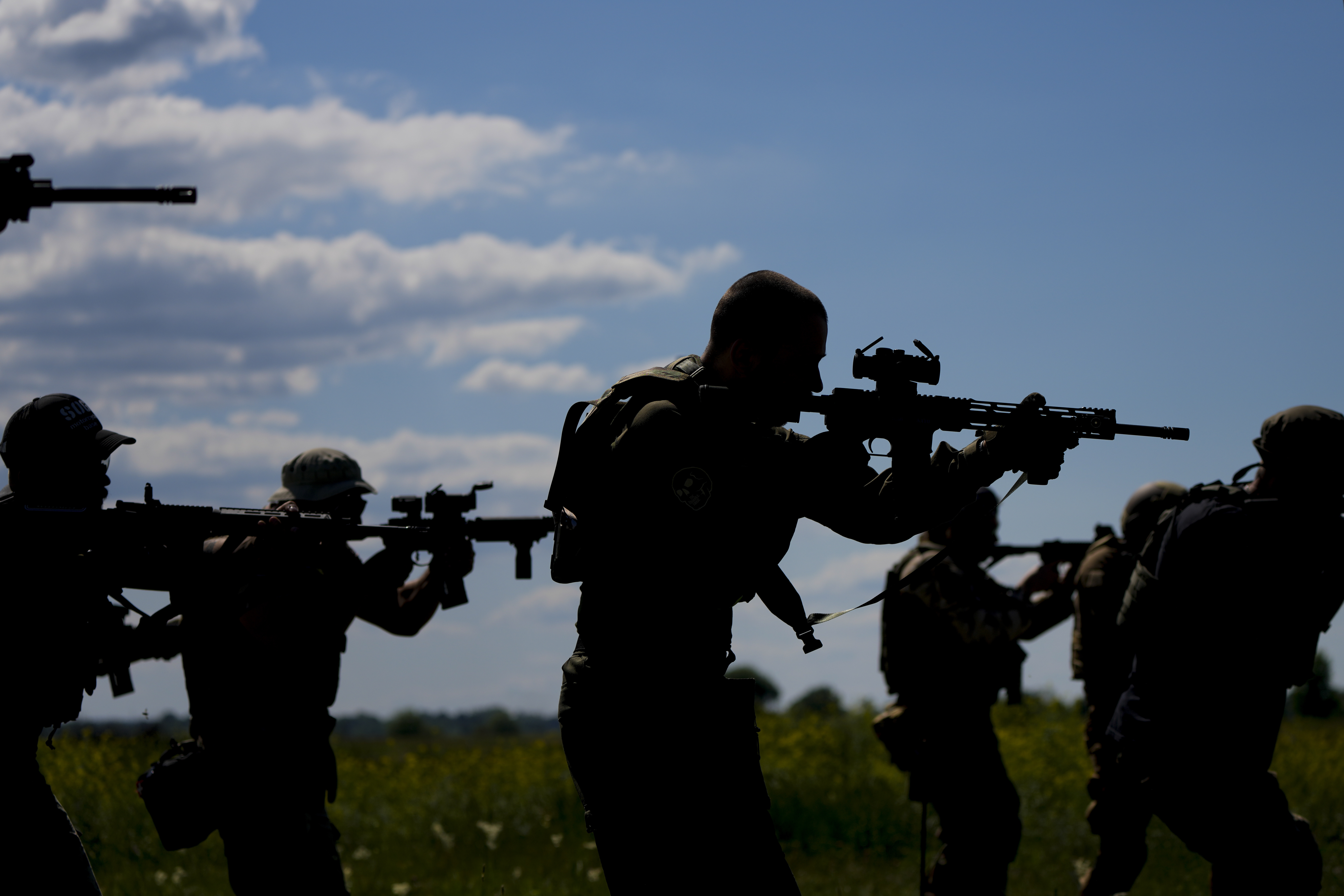 Civilian militia men hold rifles during training at a shooting range in outskirts Kyiv, Ukraine, Tuesday, June 7, 2022. (AP Photo/Natacha Pisarenko)