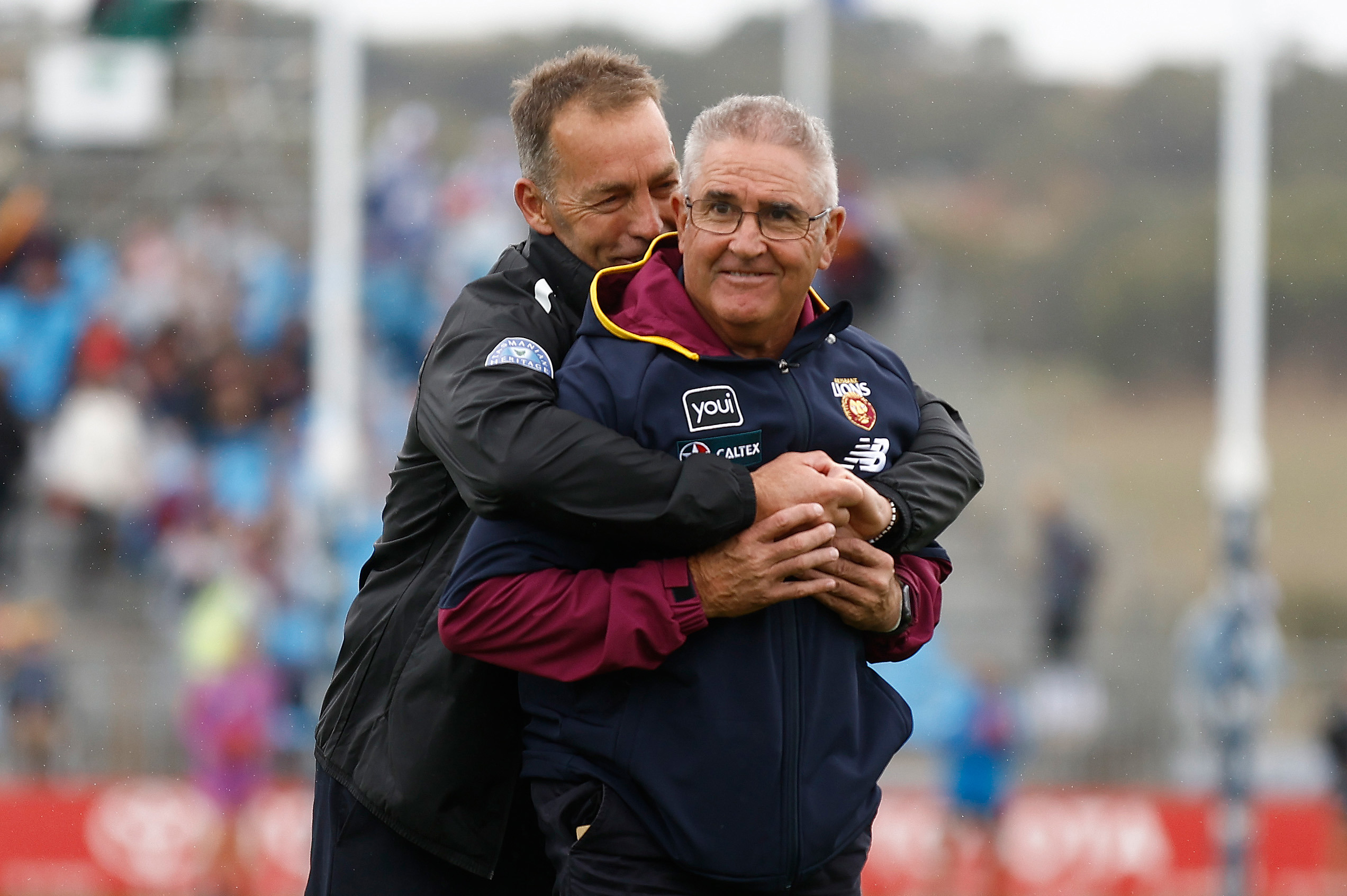 ADELAIDE, AUSTRALIA - APRIL 15: Chris Fagan, Senior Coach of the Lions and Alastair Clarkson, Senior Coach of the Kangaroos embrace before the 2023 AFL Round 05 match between the Brisbane Lions and the North Melbourne Kangaroos at Adelaide Hills on April 15, 2023 in Adelaide, Australia. (Photo by Michael Willson/AFL Photos)