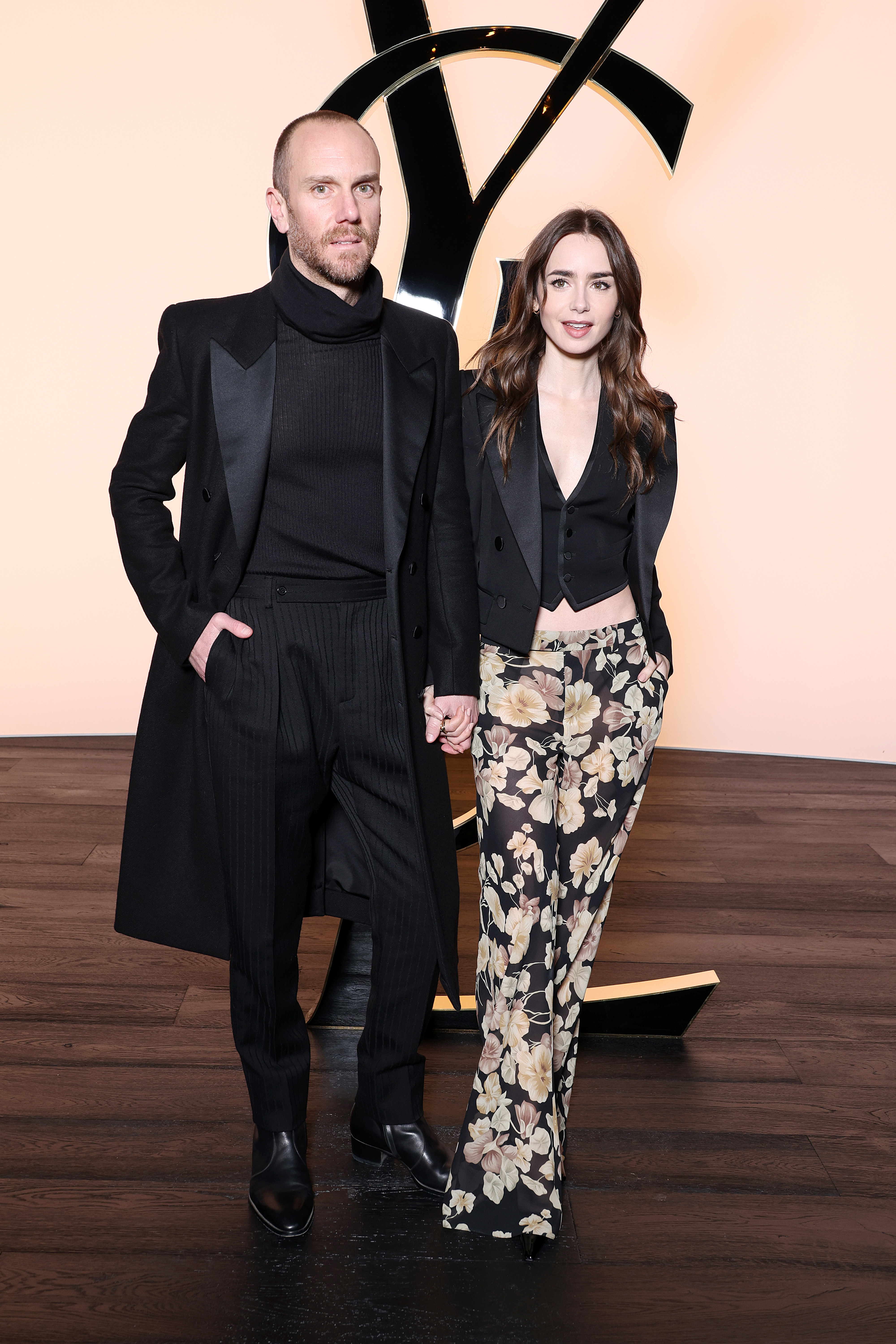 Charlie McDowell and Lily Collins attend the Saint Laurent Womenswear Fall/Winter 2024-2025 show as part of Paris Fashion Week on February 27, 2024 in Paris, France. 