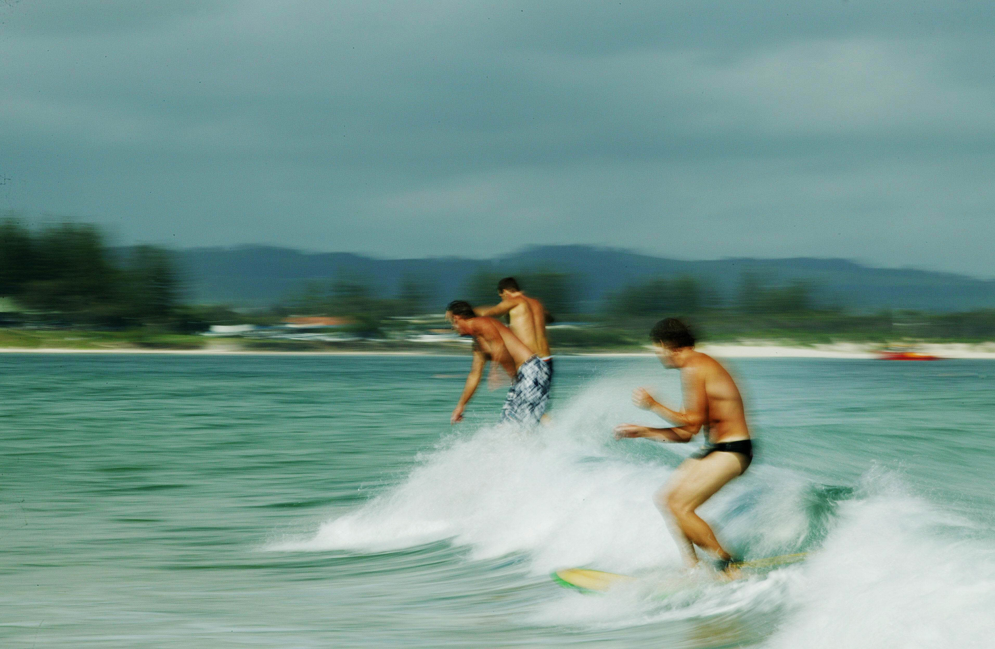 Surfers at The Pass, a beach at Byron Bay on the NSW North Coast. 