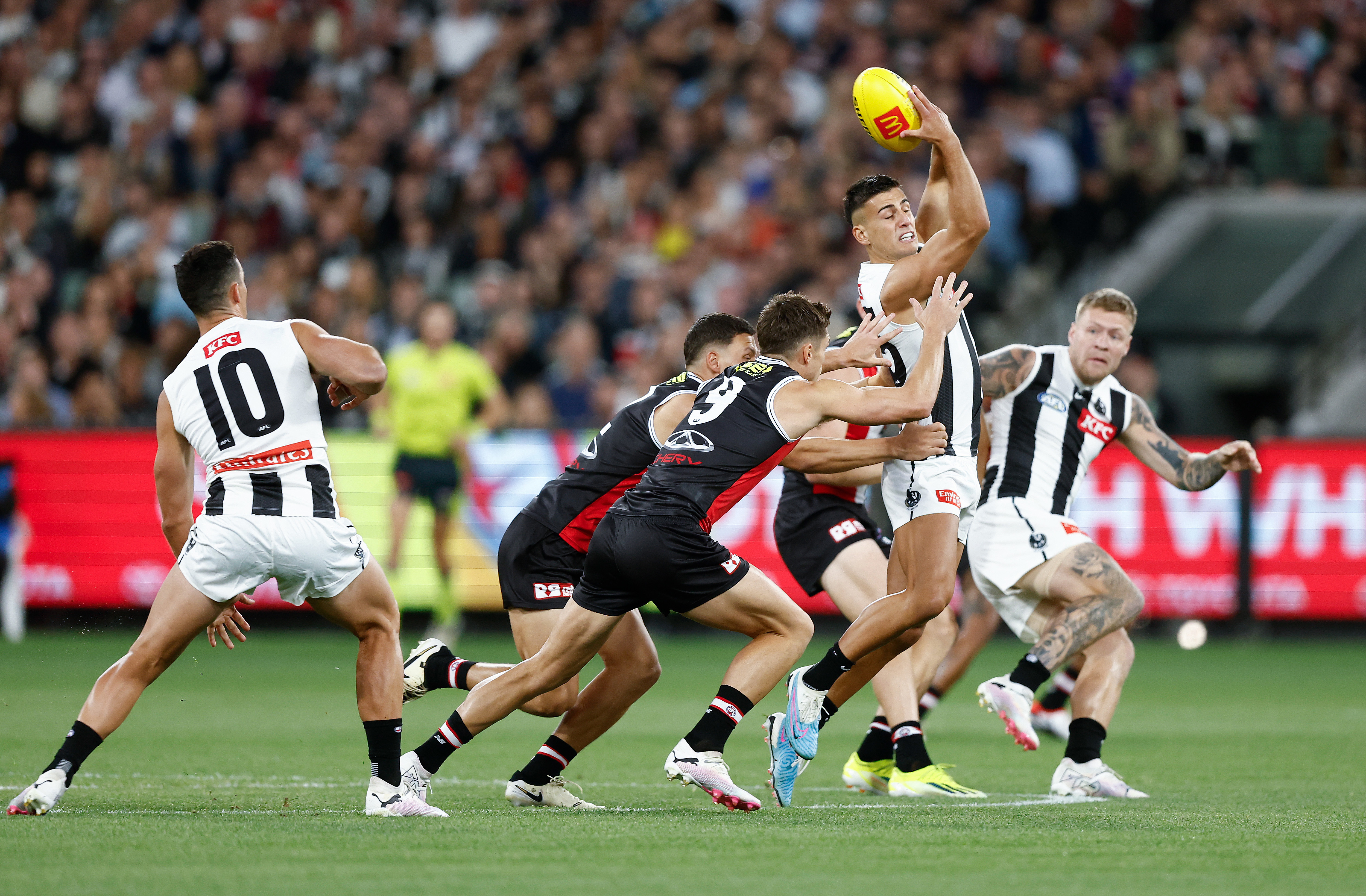 Nick Daicos of the Magpies handballs against St Kilda.