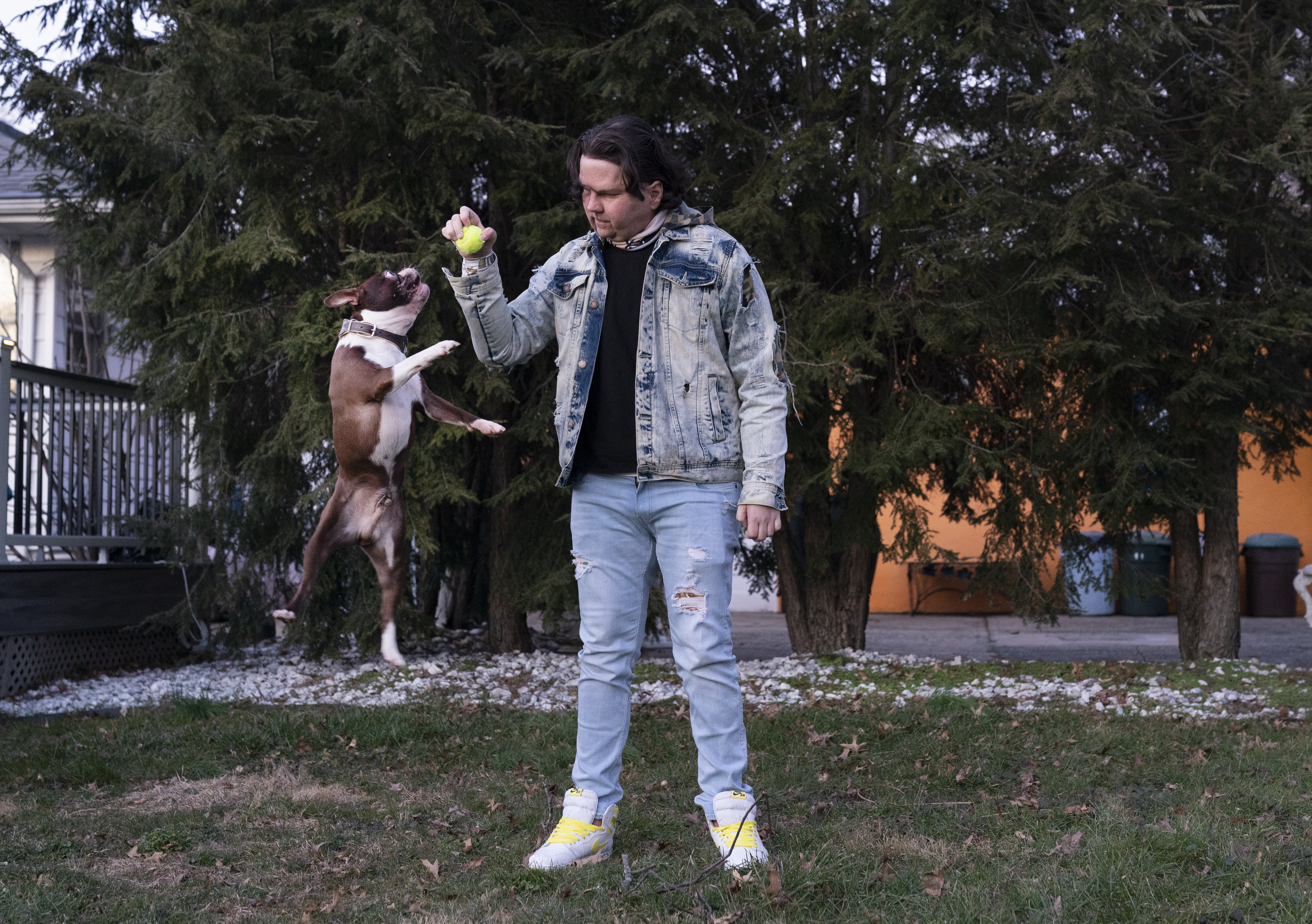 Joe DiMeo plays ball with his dog Buster in the backyard of his house, six months after an extremely rare double hand and face transplant. (AP Photo/Mark Lennihan)