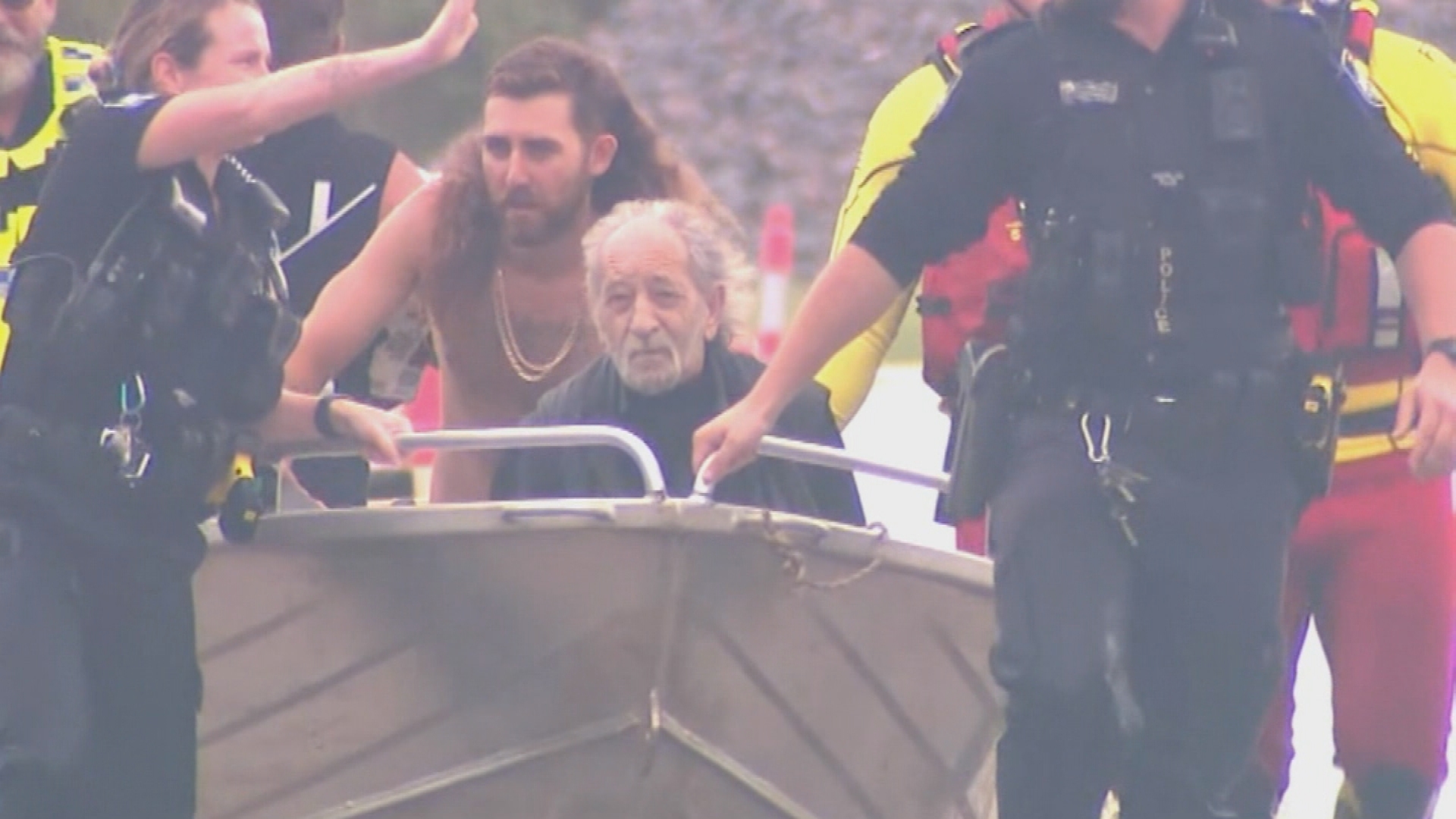 Two tradies have rescued an elderly man who became trapped in his car while it was being washed away by floodwaters in Queensland's Moreton Bay region.