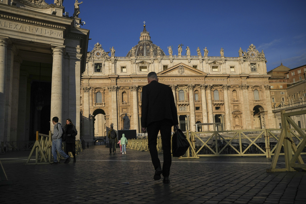 People walk in St. Peter's Square at The Vatican, Sunday, Feb. 23, 2025, ahead of a mass for the Jubilee of Deacons in St. Peter's Basilica that was supposed to be presided over by Pope Francis who was admitted at Rome's Agostino Gemelli Polyclinic over a week ago and is in critical conditions. (AP Photo/Alessandra Tarantino)