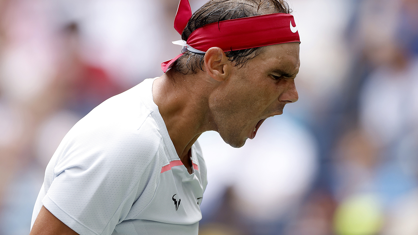 Portrait of Spanish tennis player Rafael Nadal tying headband