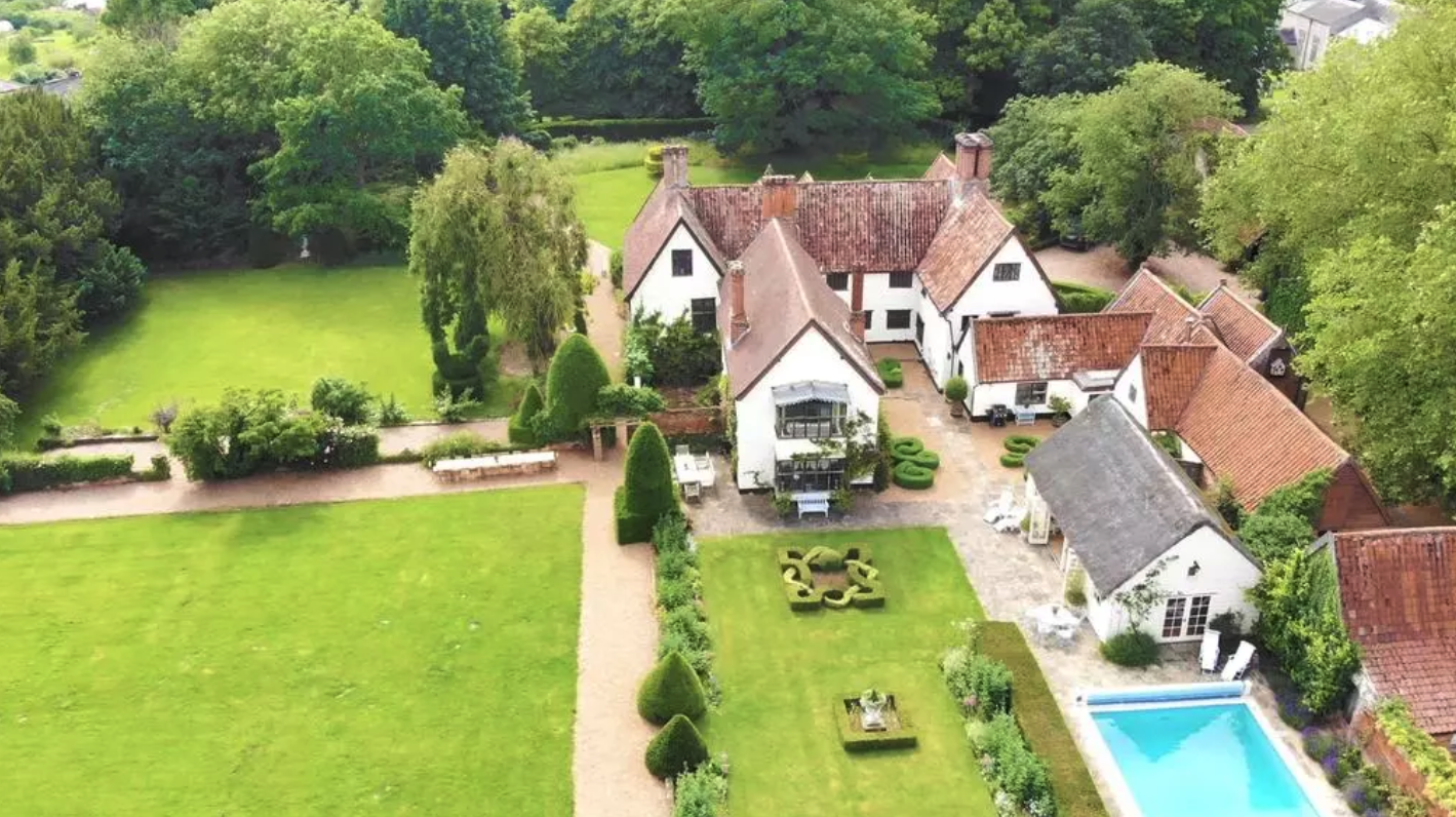 The property includes multiple out-buildings, a pool, gardens and tennis court.