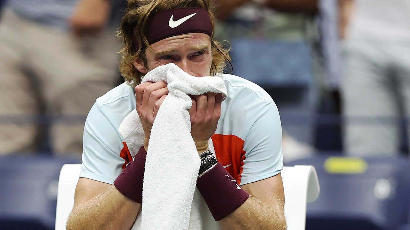 Andrey Rublev wipes away tears during his US Open quarter final against Frances Tiafoe.