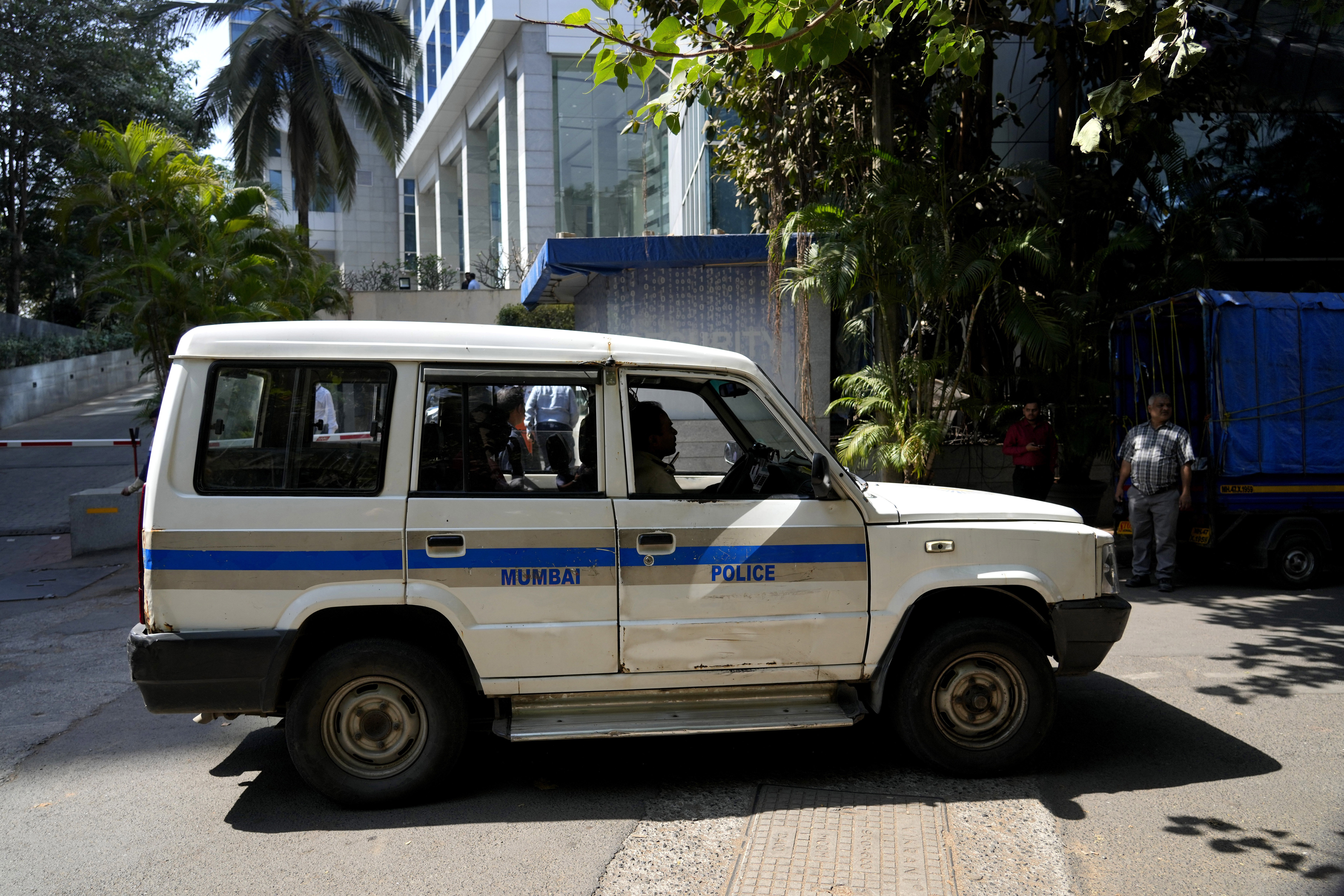 A police vehicle is seen parked at the gate of a building which houses BBC office, in Mumbai, India, Tuesday, Feb. 14, 2023.