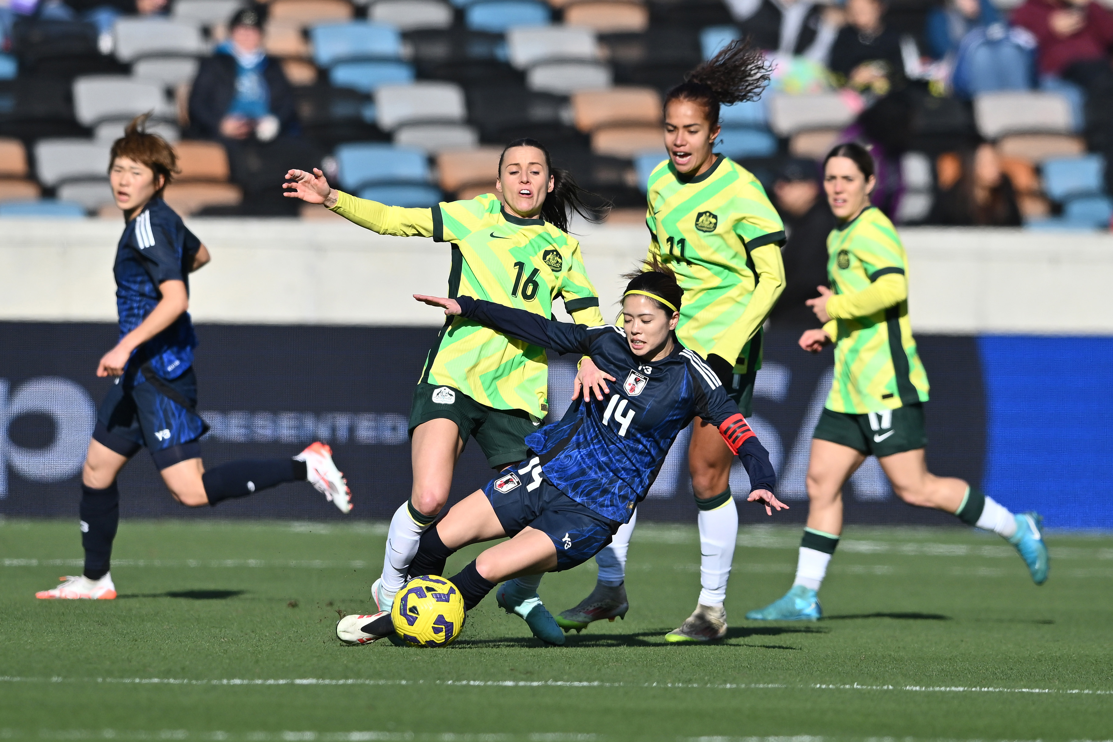 Yui Hasegawa #14 of Japan is tackled by Hayley Raso.