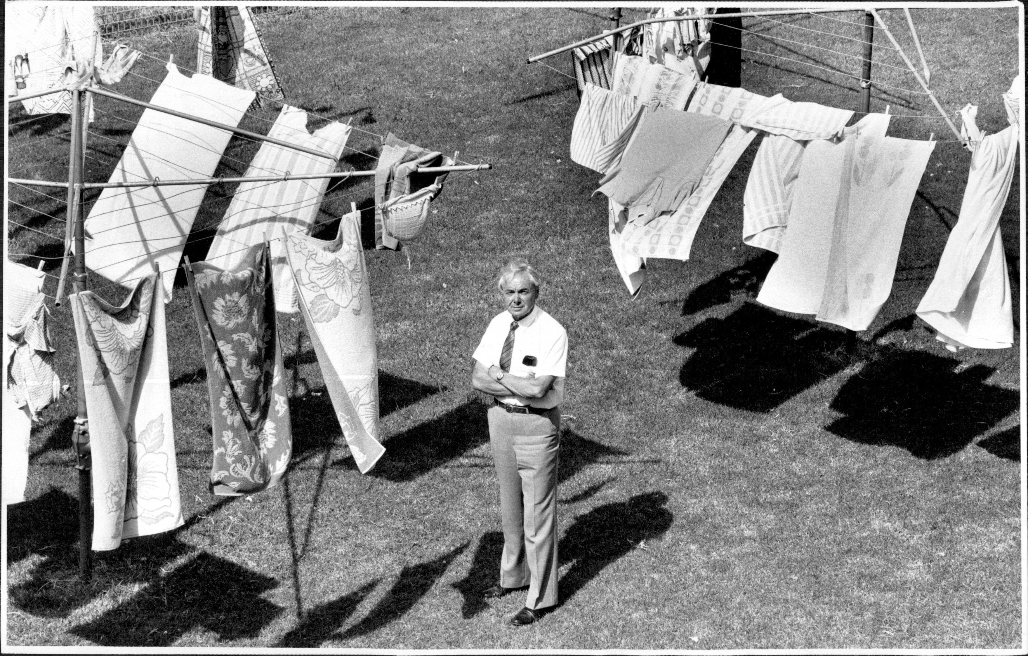 Gerald Wright, Regional Director of the New South Wales Branch of Hills with a Backyard of Hills Hoists. February 13, 1989.